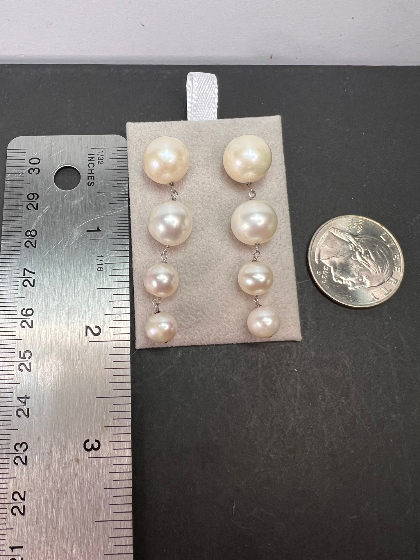 Graduated dangling pearl earrings in sterling silver