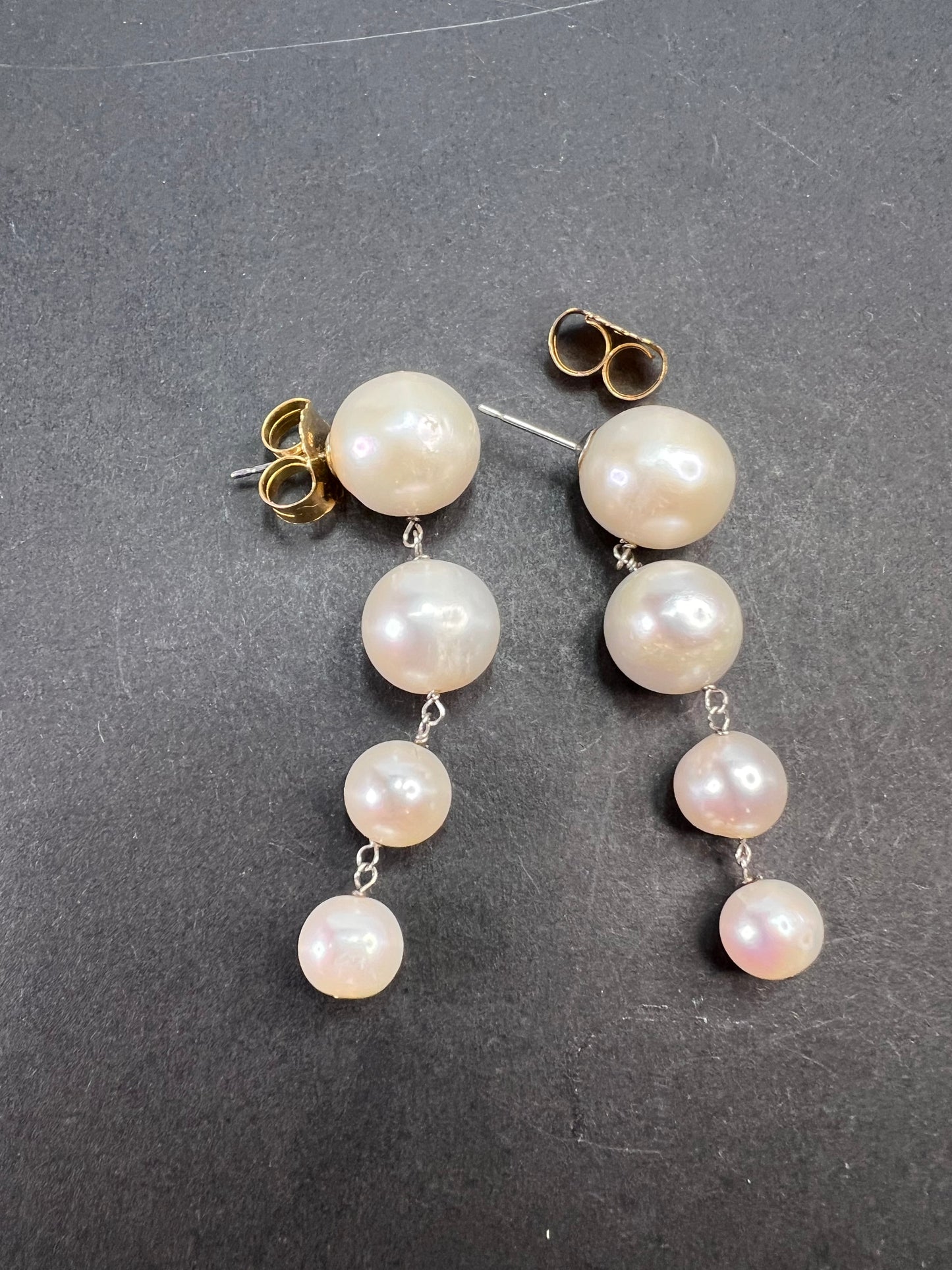 Graduated dangling pearl earrings in sterling silver