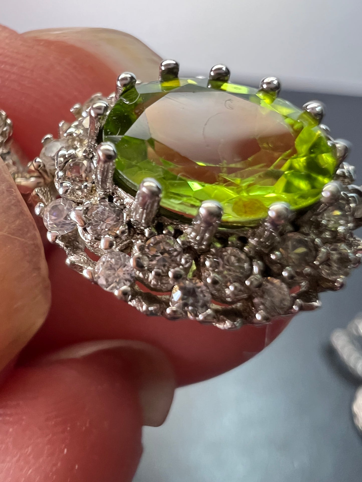 Manchurian Peridot and zircon drop halo earrings in rhodium over sterling silver 5.42 ctw