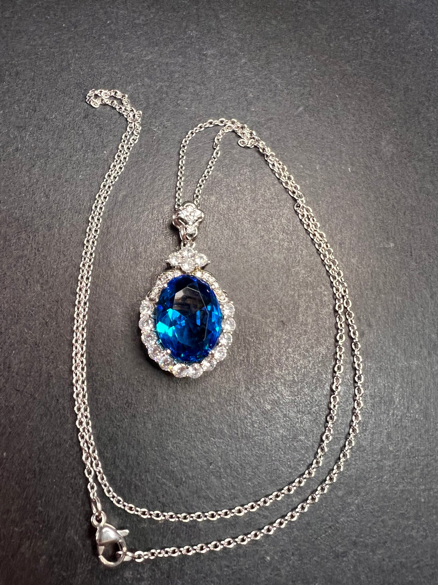 Blue and white CZ sterling silver halo pendant