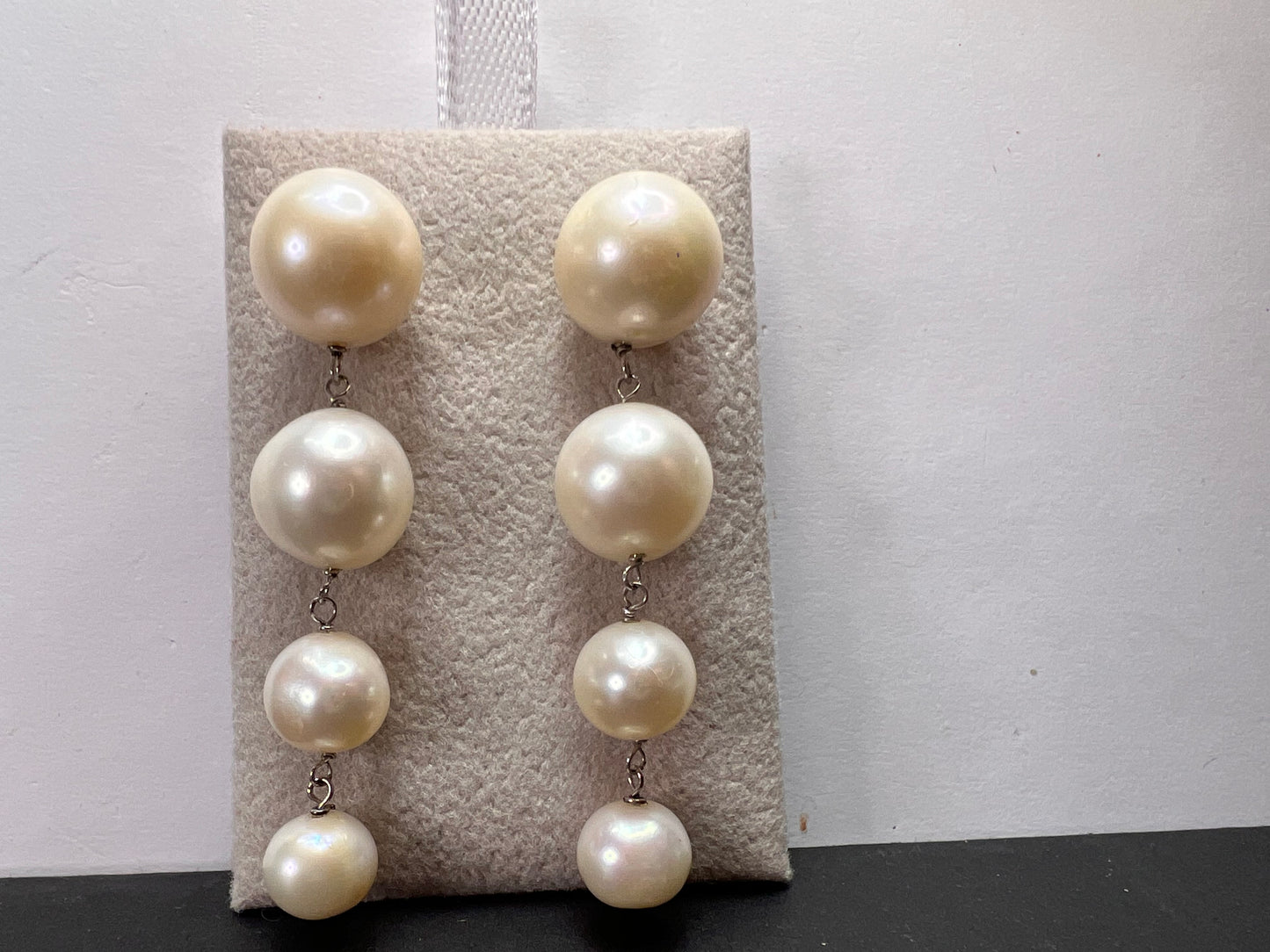 Graduated dangling pearl earrings in sterling silver