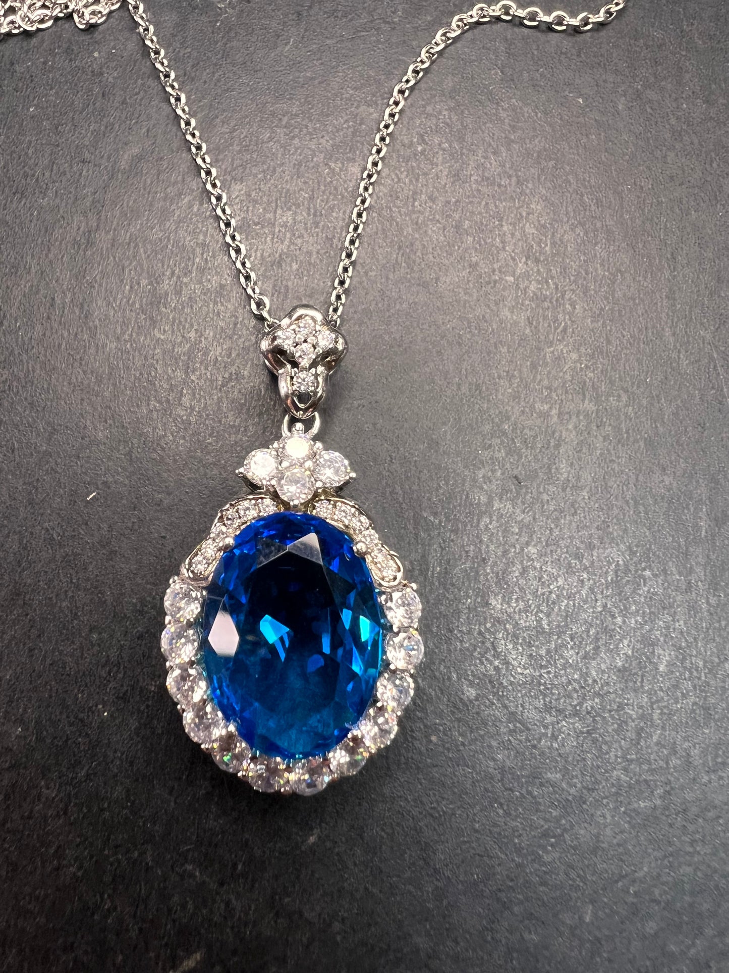 Blue and white CZ sterling silver halo pendant