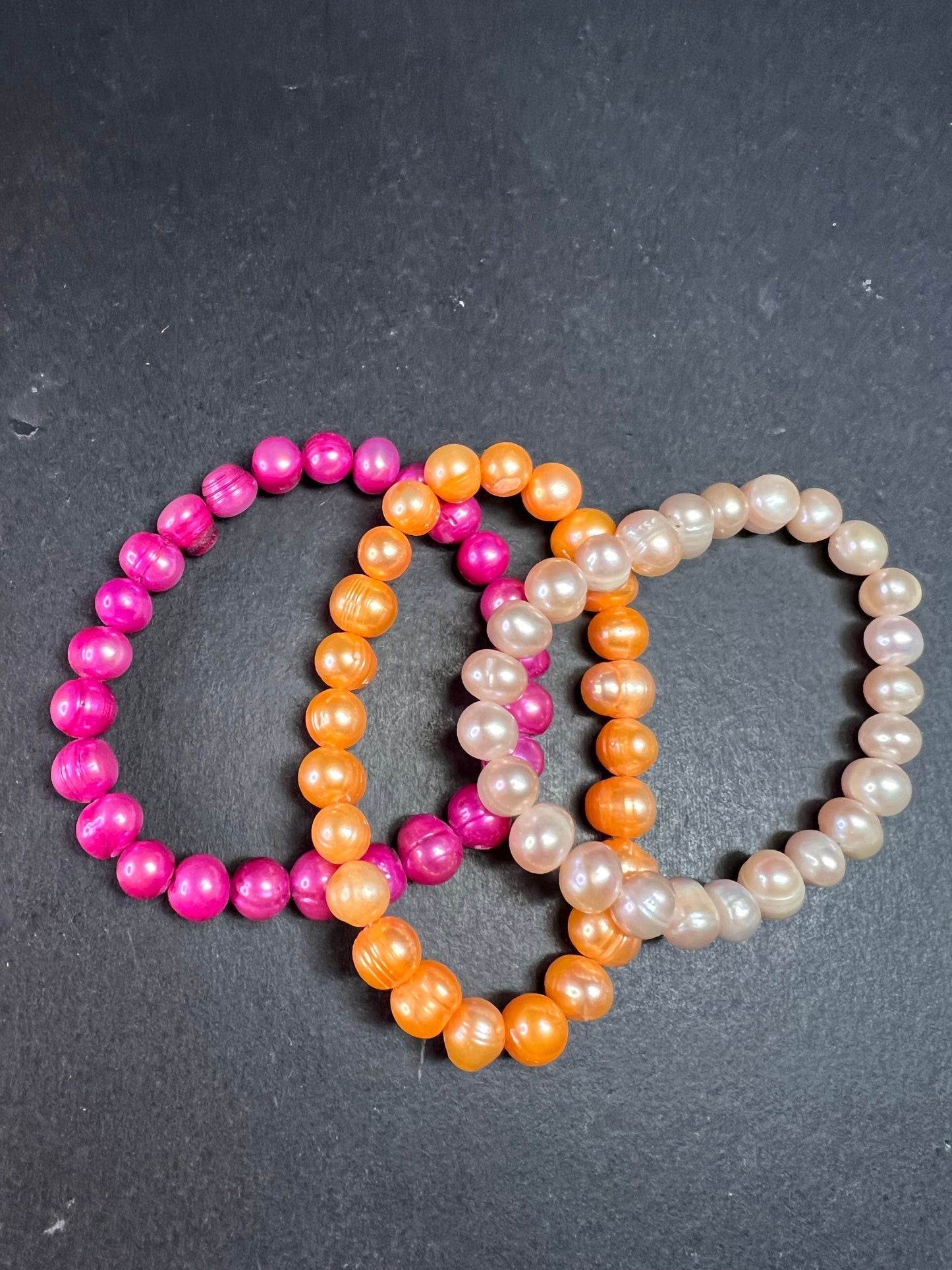 Set of three freshwater pearl stretch bracelets fuchsia pink to tangerine