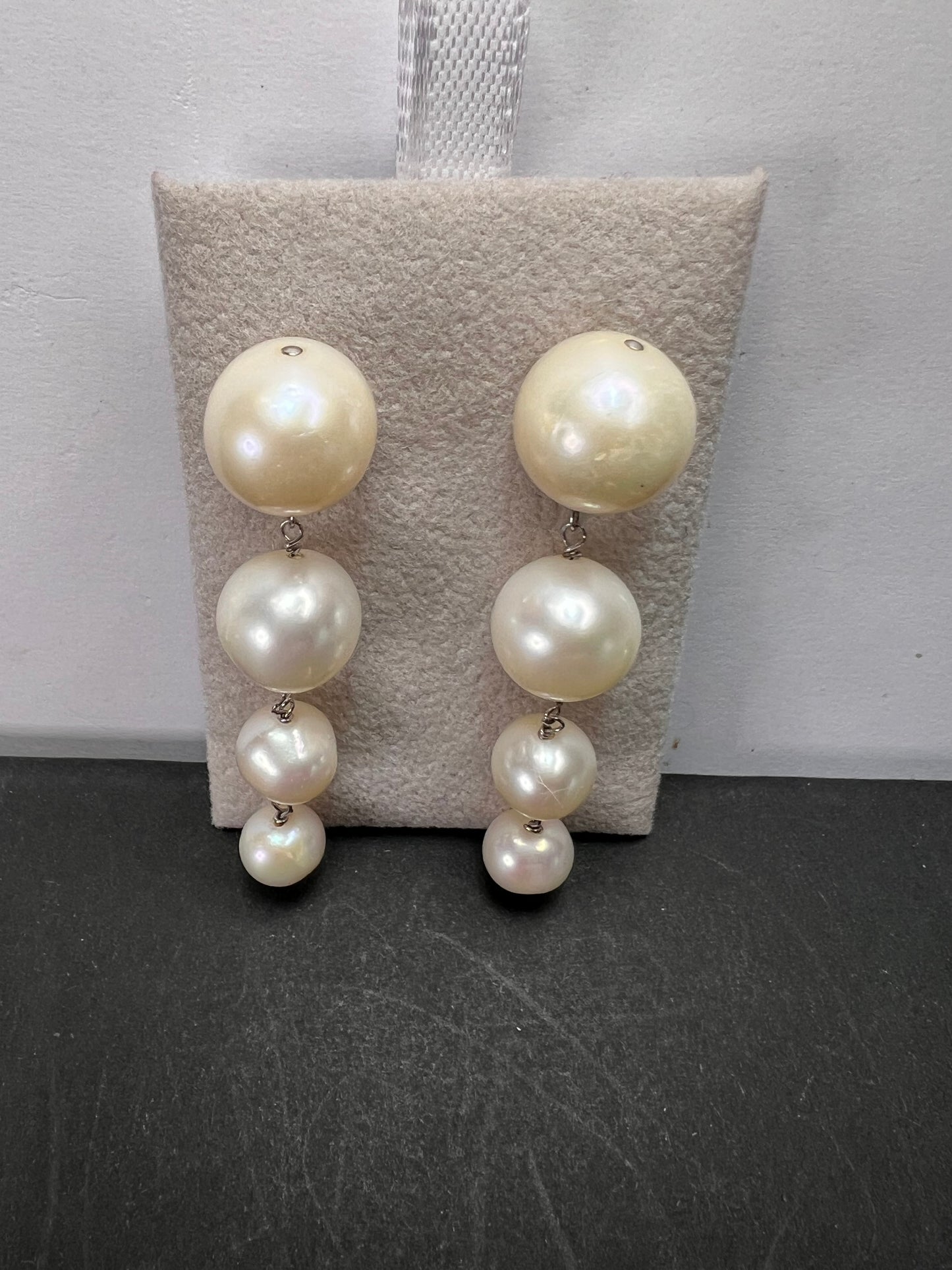 Graduated dangling pearl earrings in sterling silver