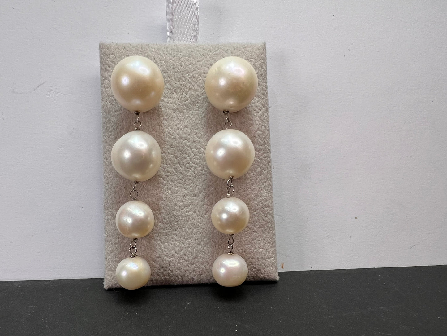 Graduated dangling pearl earrings in sterling silver