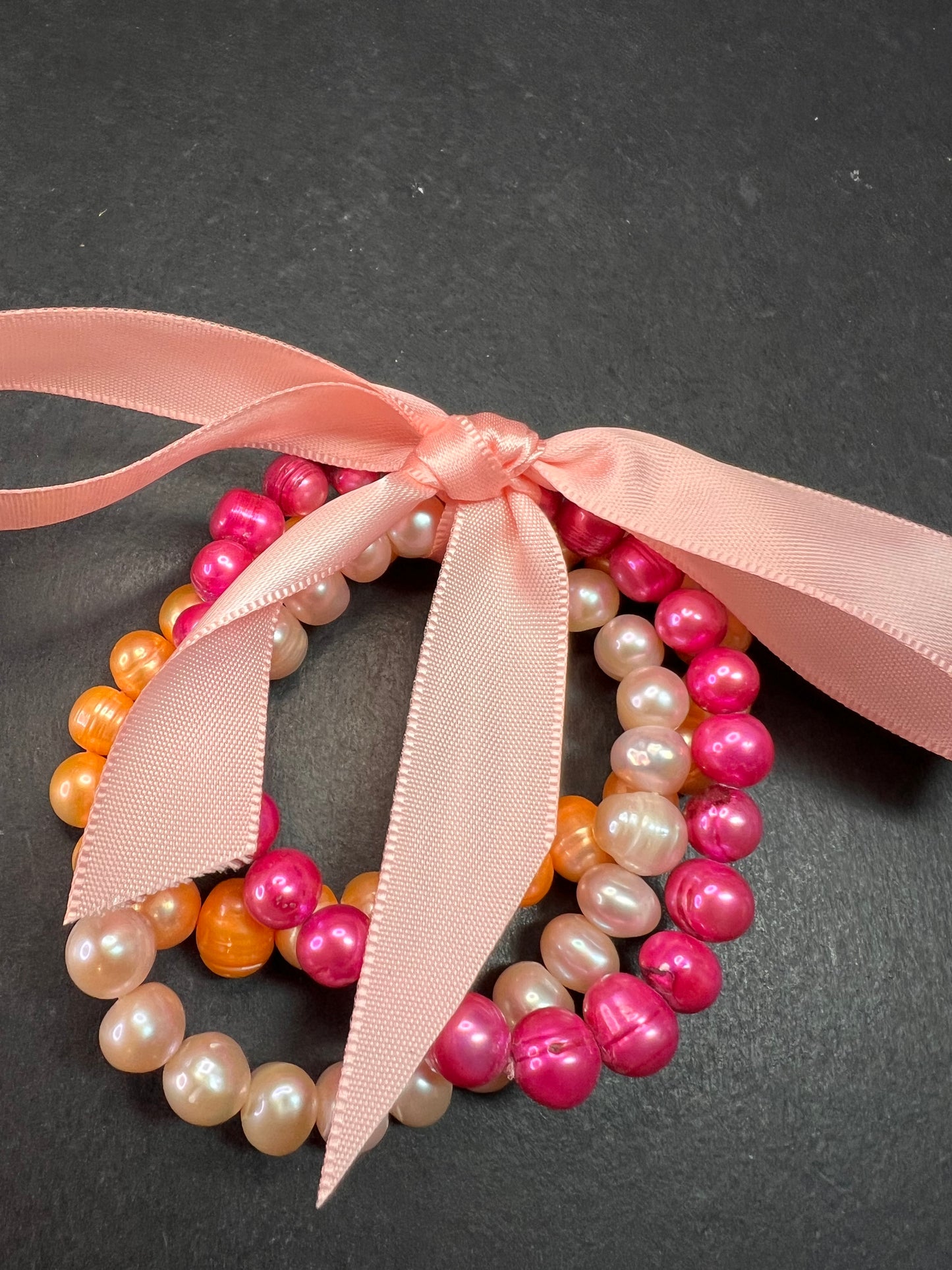 Set of three freshwater pearl stretch bracelets fuchsia pink to tangerine