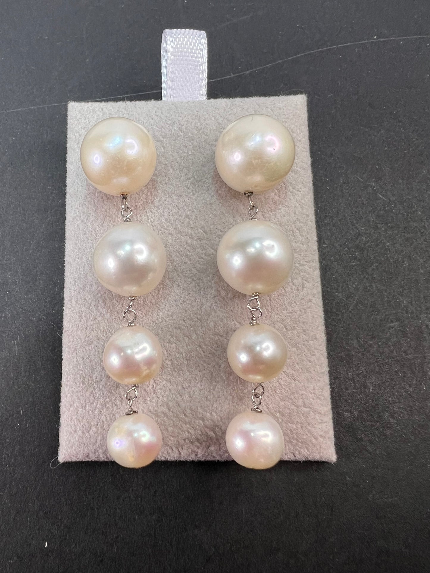 Graduated dangling pearl earrings in sterling silver