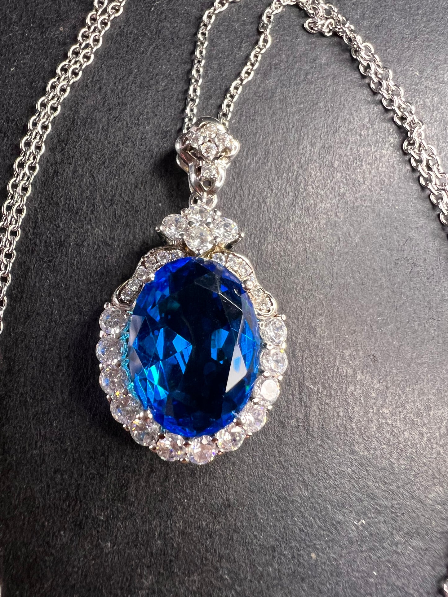 Blue and white CZ sterling silver halo pendant