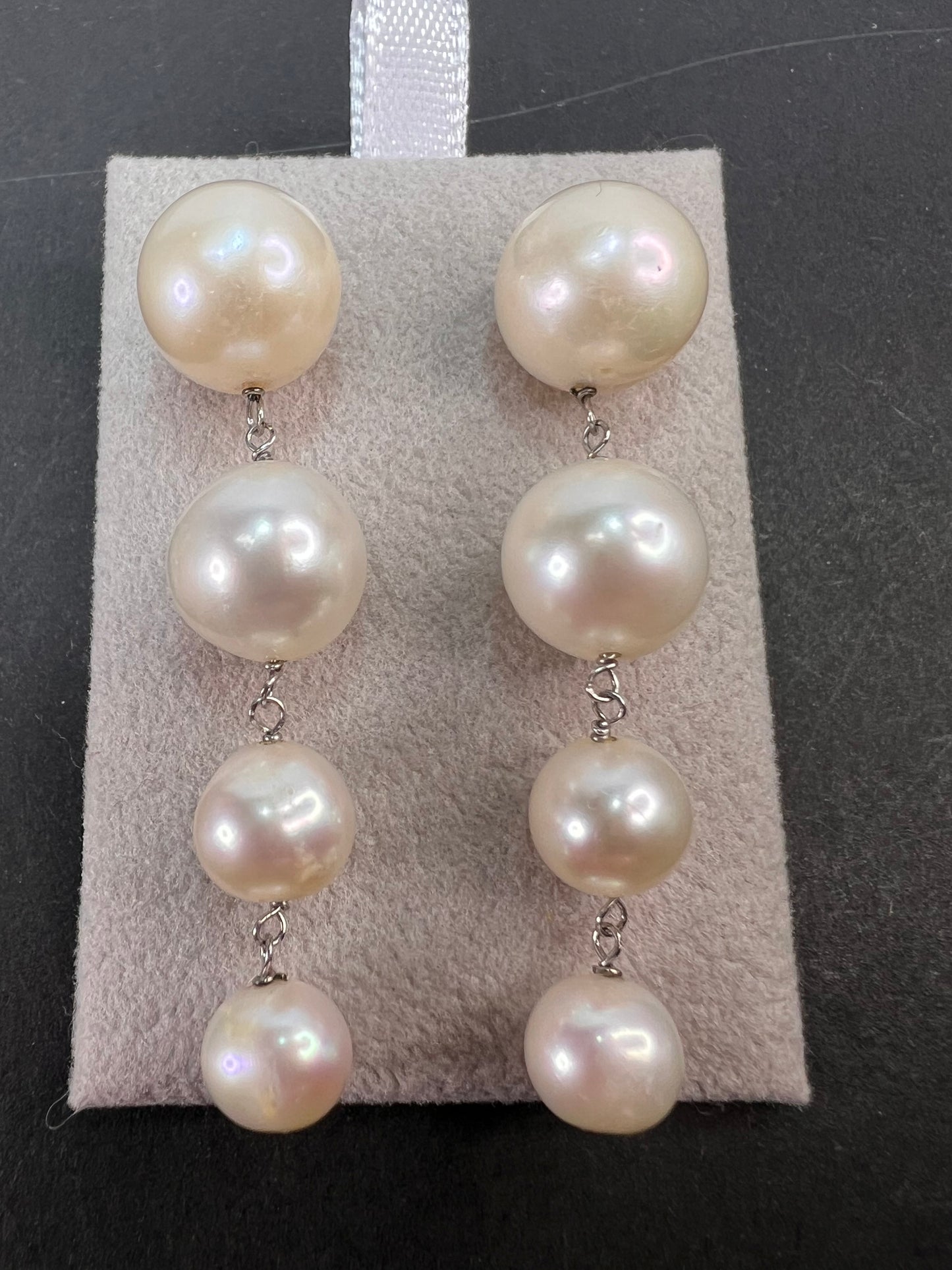 Graduated dangling pearl earrings in sterling silver