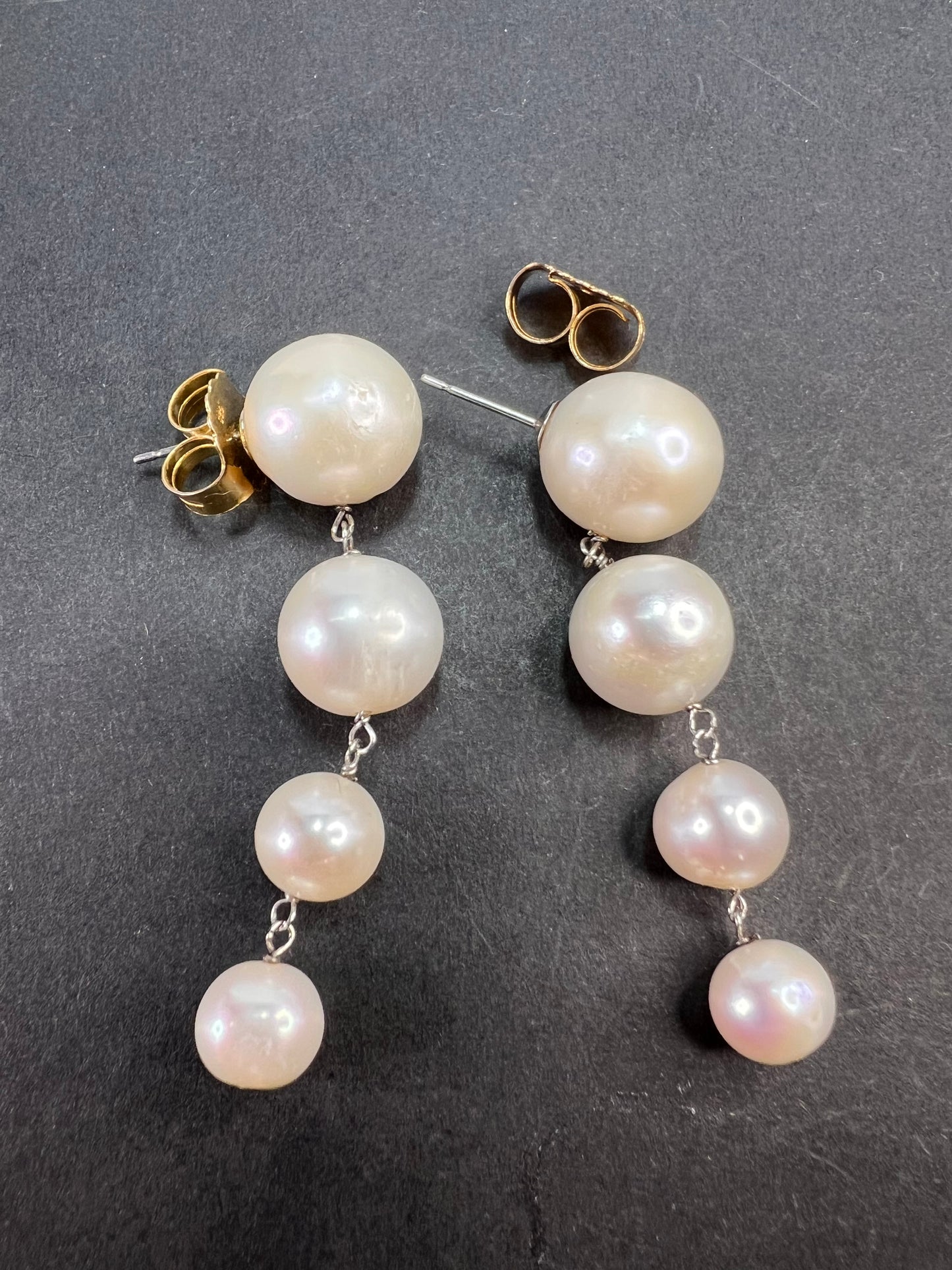 Graduated dangling pearl earrings in sterling silver