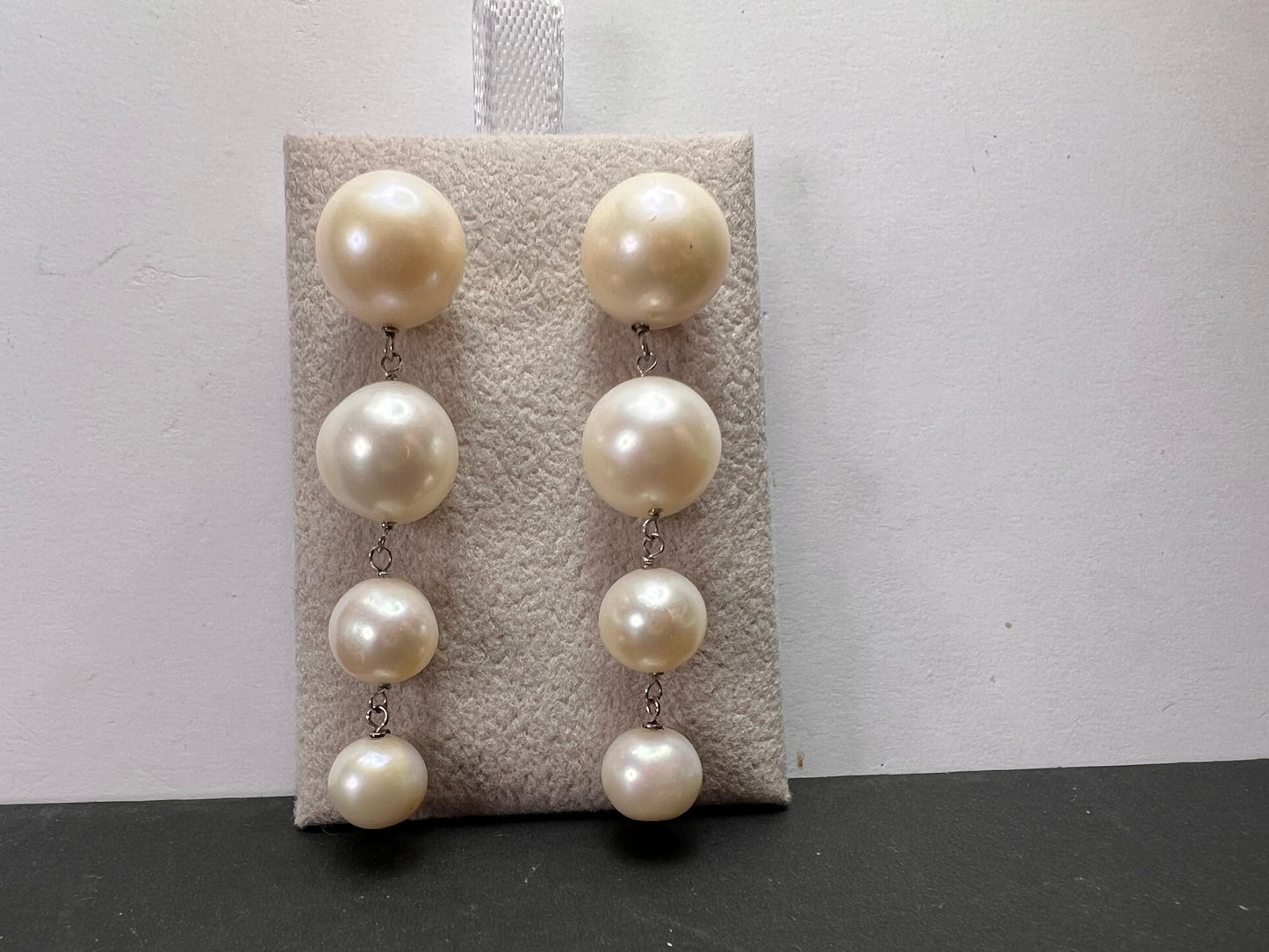 Graduated dangling pearl earrings in sterling silver