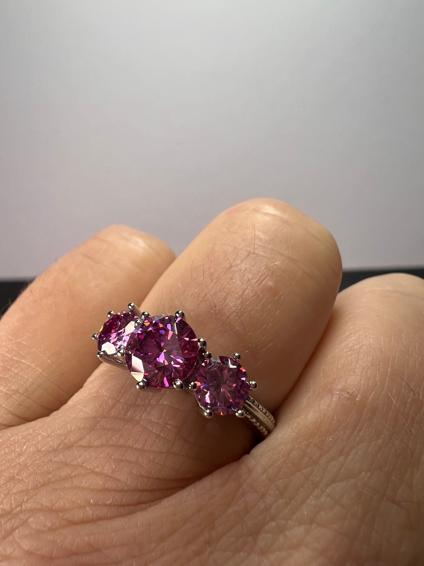 Pink moissanite trilogy ring in platinum over sterling silver size 7