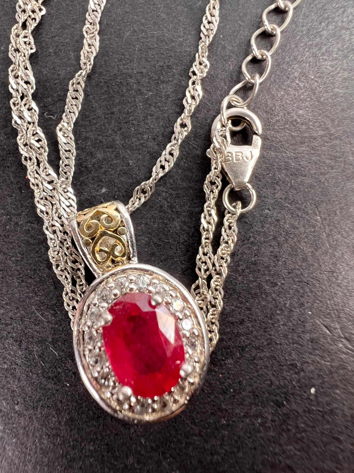 Ruby and zircon two toned halo pendant and chain necklace in sterling silver