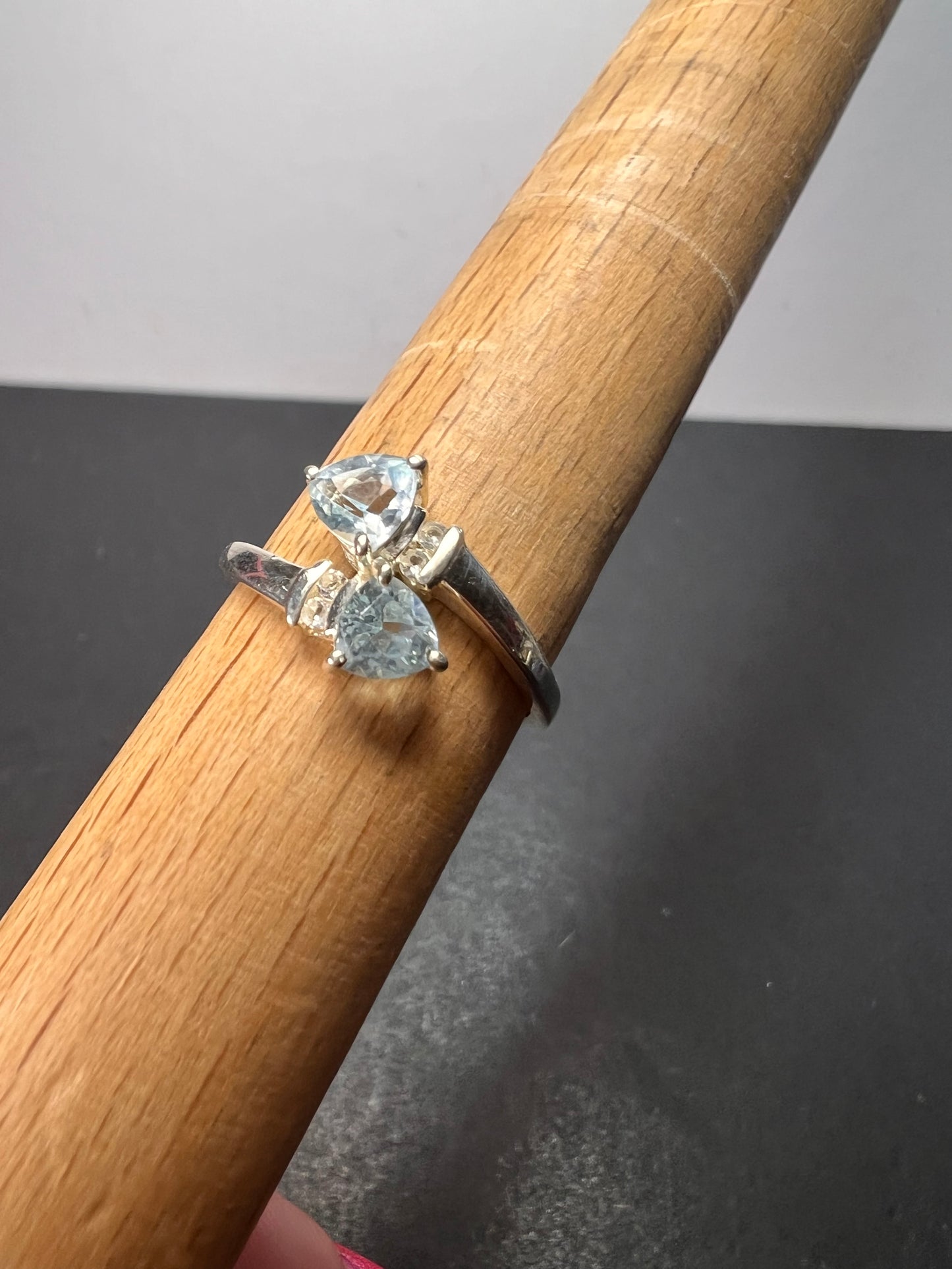 Trillion cut blue topaz bypass ring in rhodium over sterling silver size 9