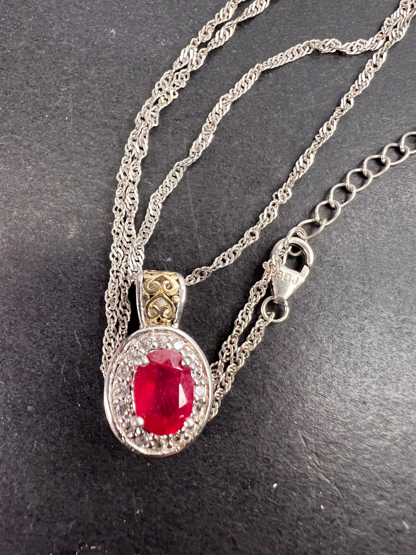 Ruby and zircon two toned halo pendant and chain necklace in sterling silver