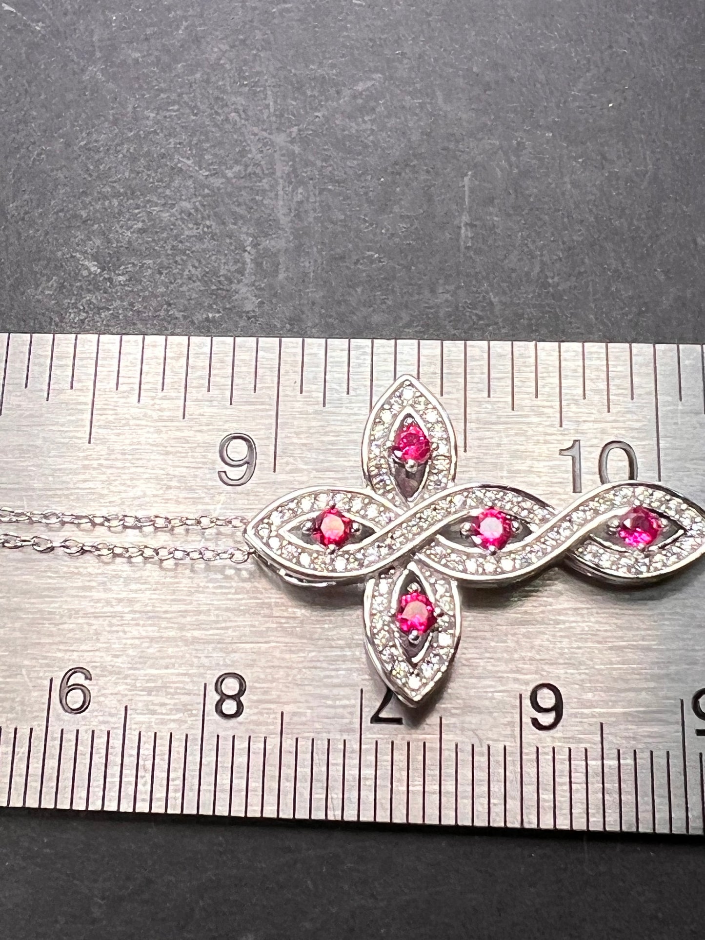 Lab grown ruby and CZ cross pendant and chain necklace in rhodium over sterling silver 18 inch