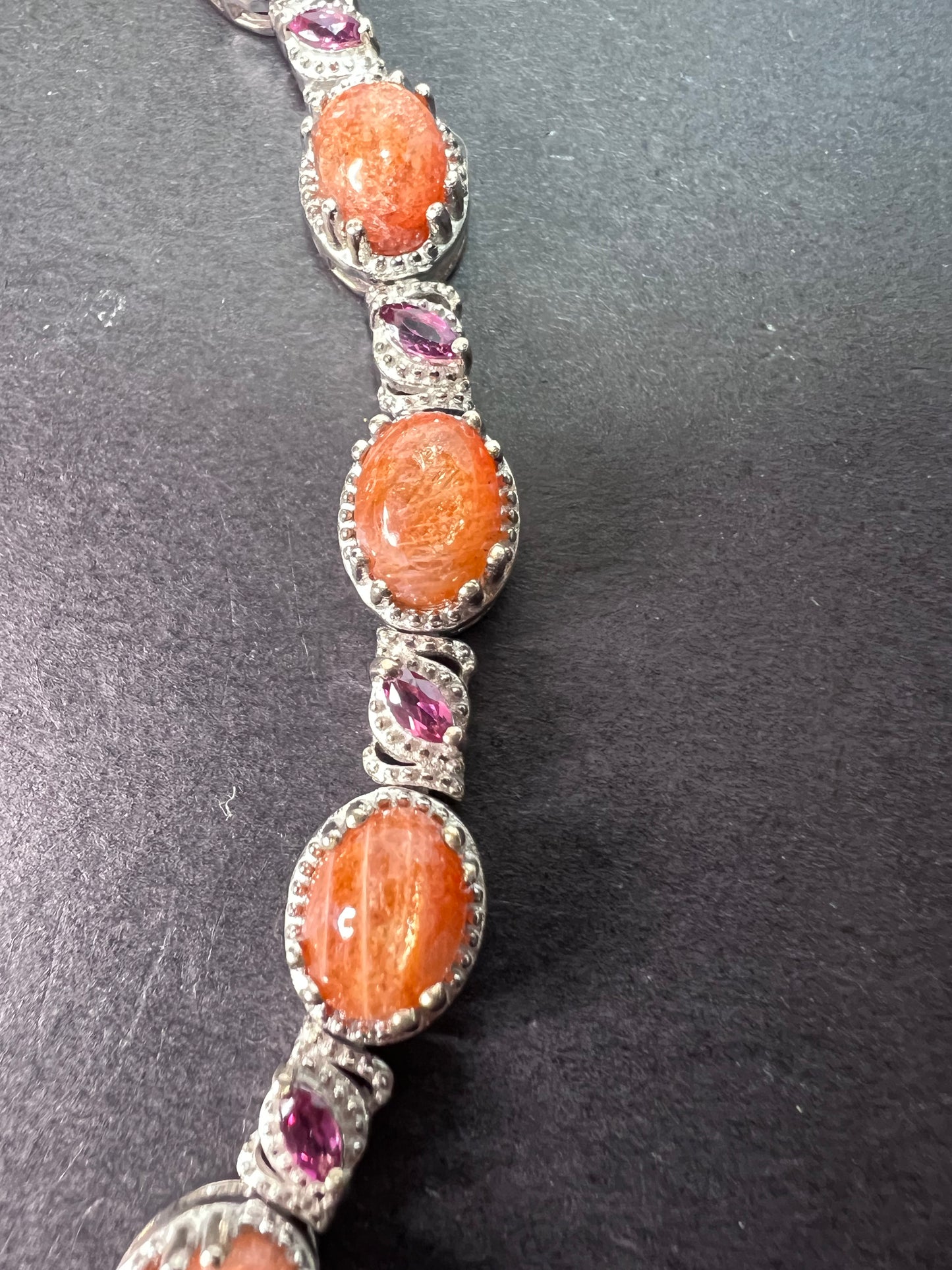 Sunstone and grape rhodolite garnet rhodium over sterling silver tennis bracelet