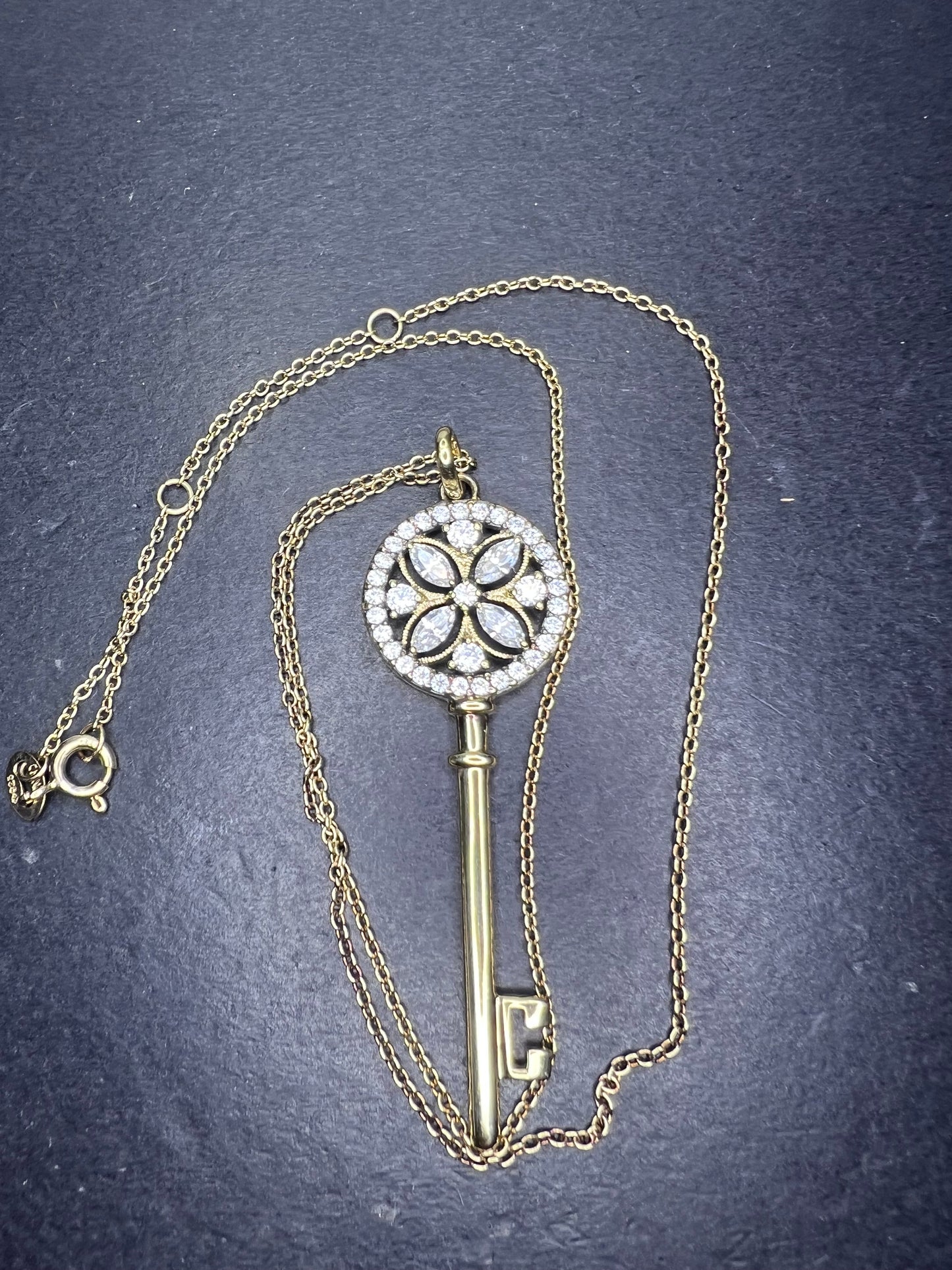 Gold over sterling silver key pendant necklace with Cz stones