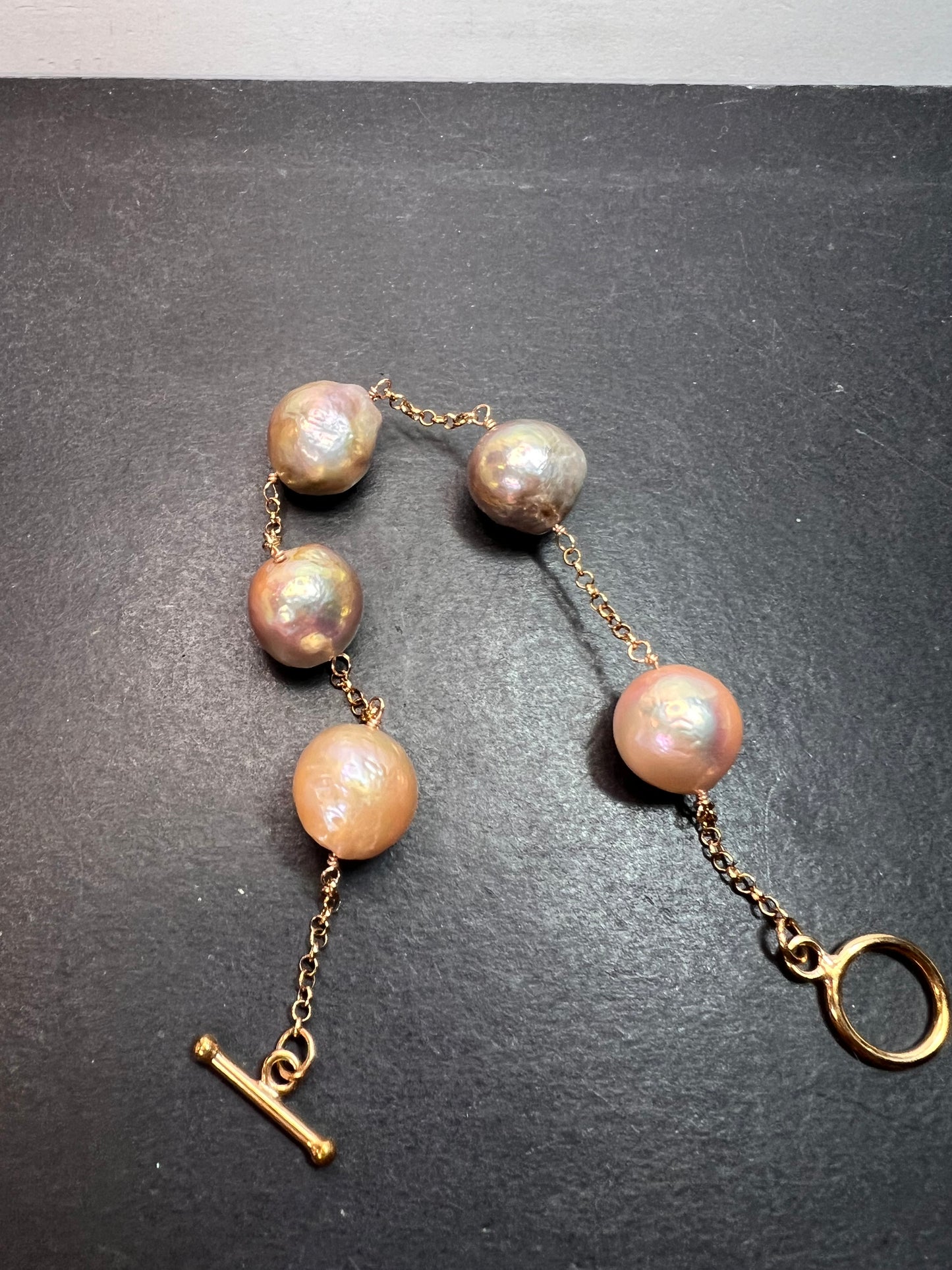 Multi colored baroque pearl station bracelet in rose gold over Sterling silver