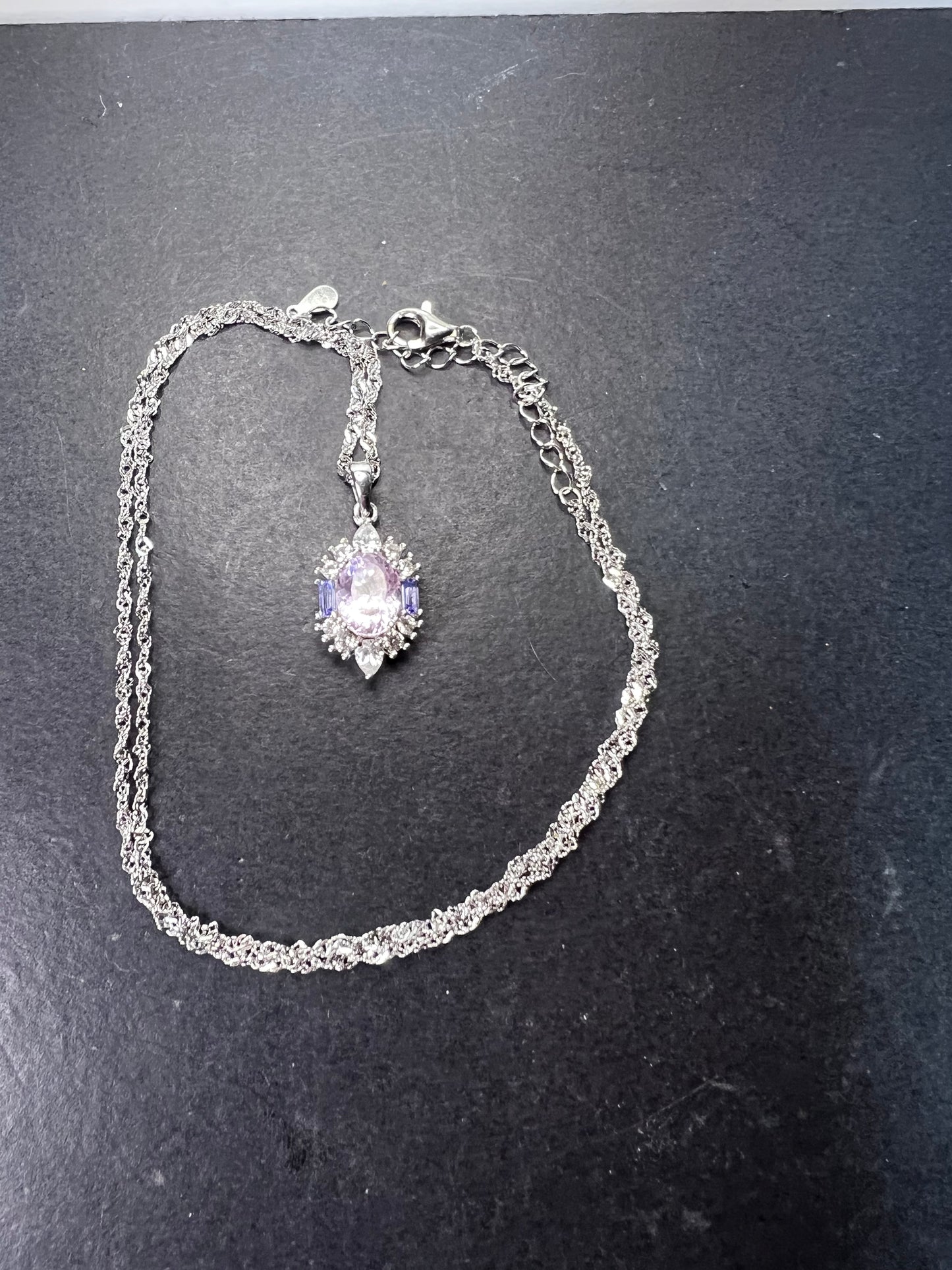 2.11ct Kunzite, 0.18ctw Tanzanite And 0.87ctw White Zircon Rhodium Over Silver halo Pendant With Chain