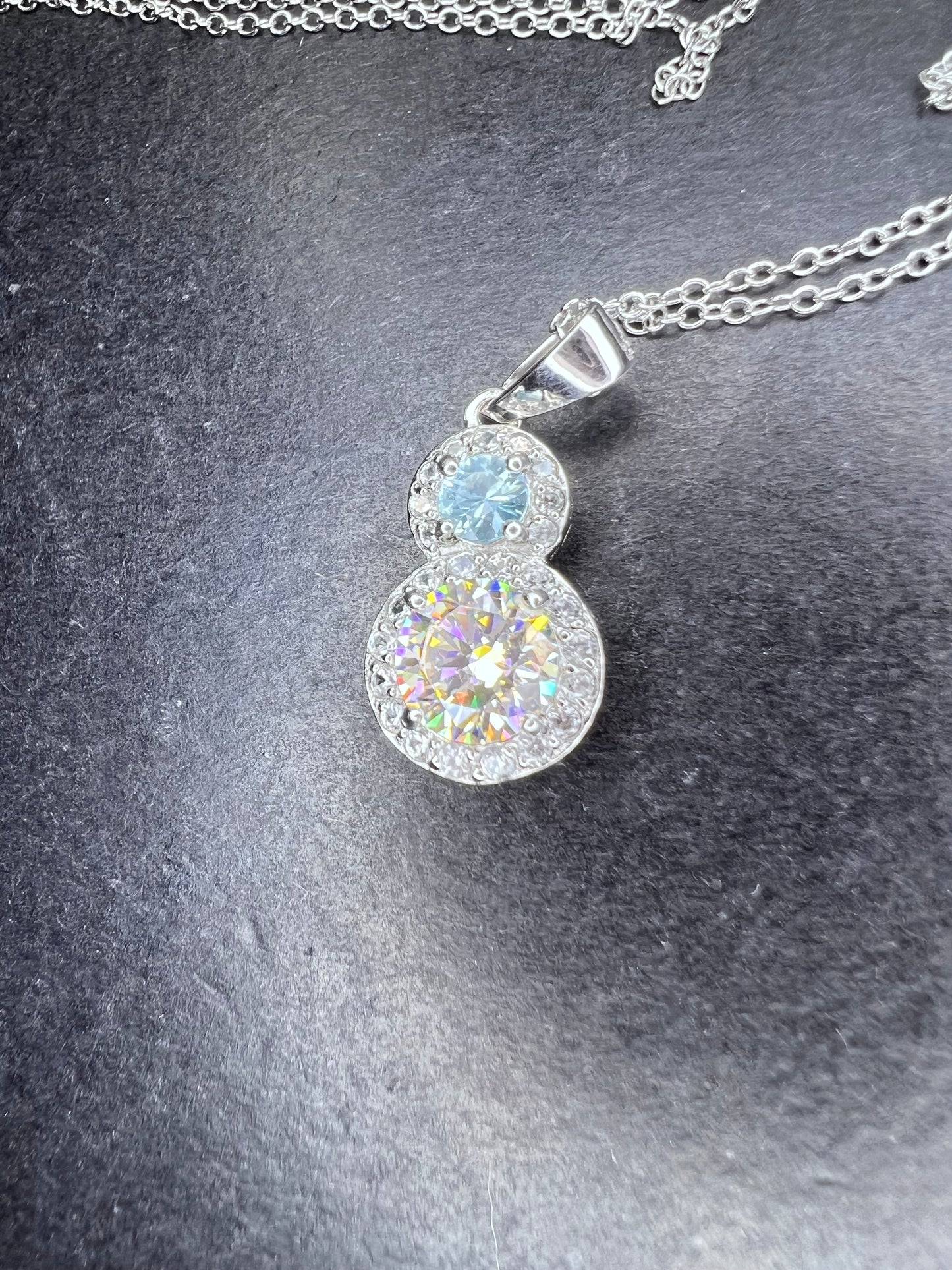 Strontium titanate and blue topaz sterling silver halo pendant with 18 inch chain necklace