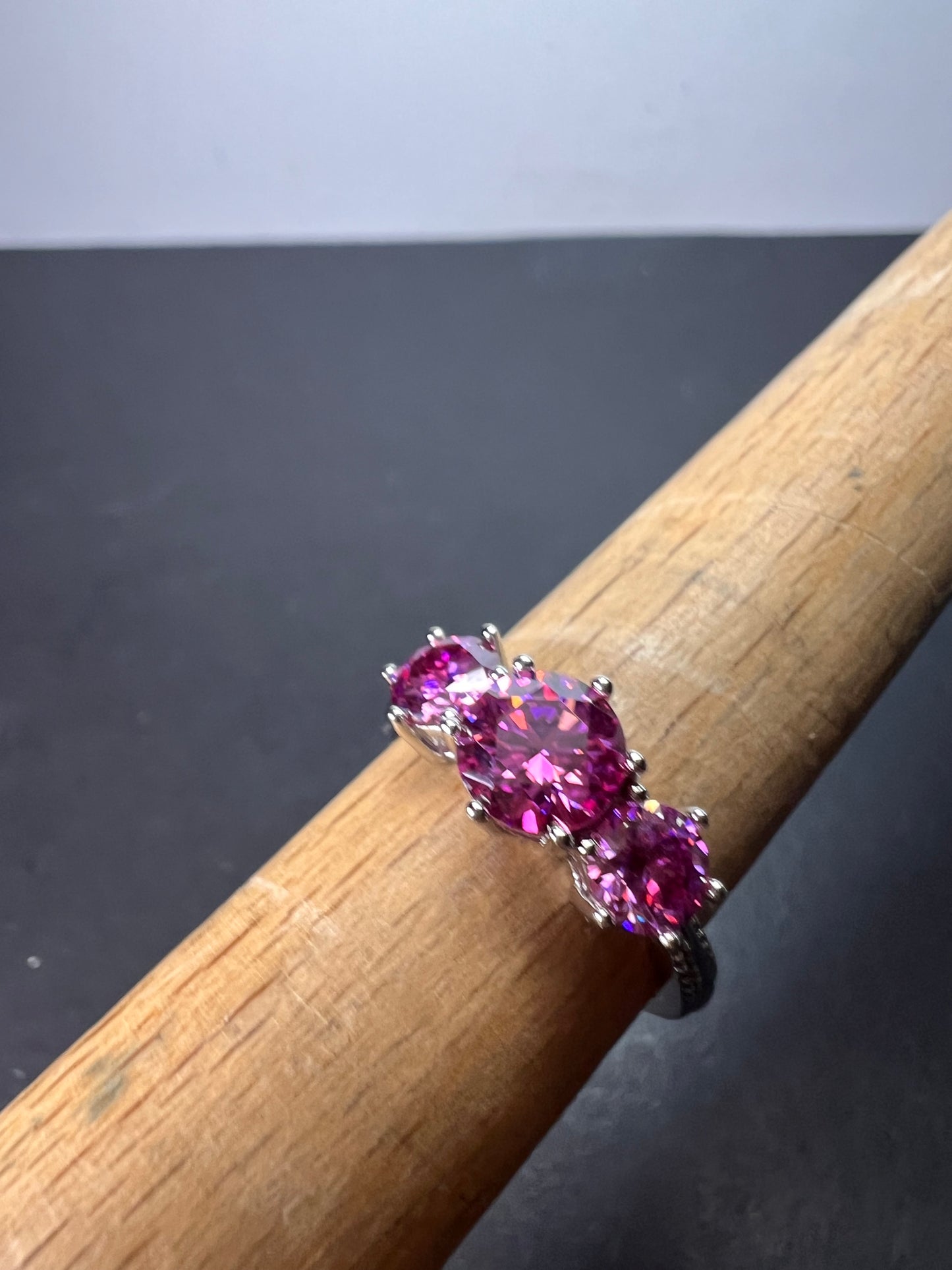 Pink moissanite trilogy ring in platinum over sterling silver size 7