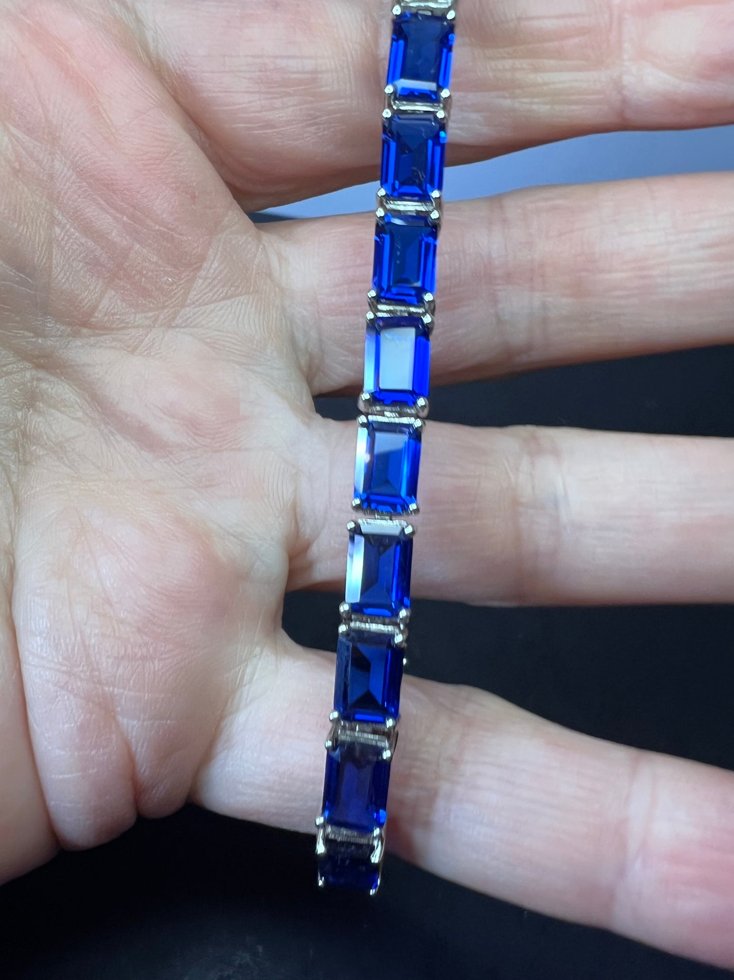 Lab created blue spinel emerald cut tennis bracelet in platinum over sterling silver 22.92 ctw