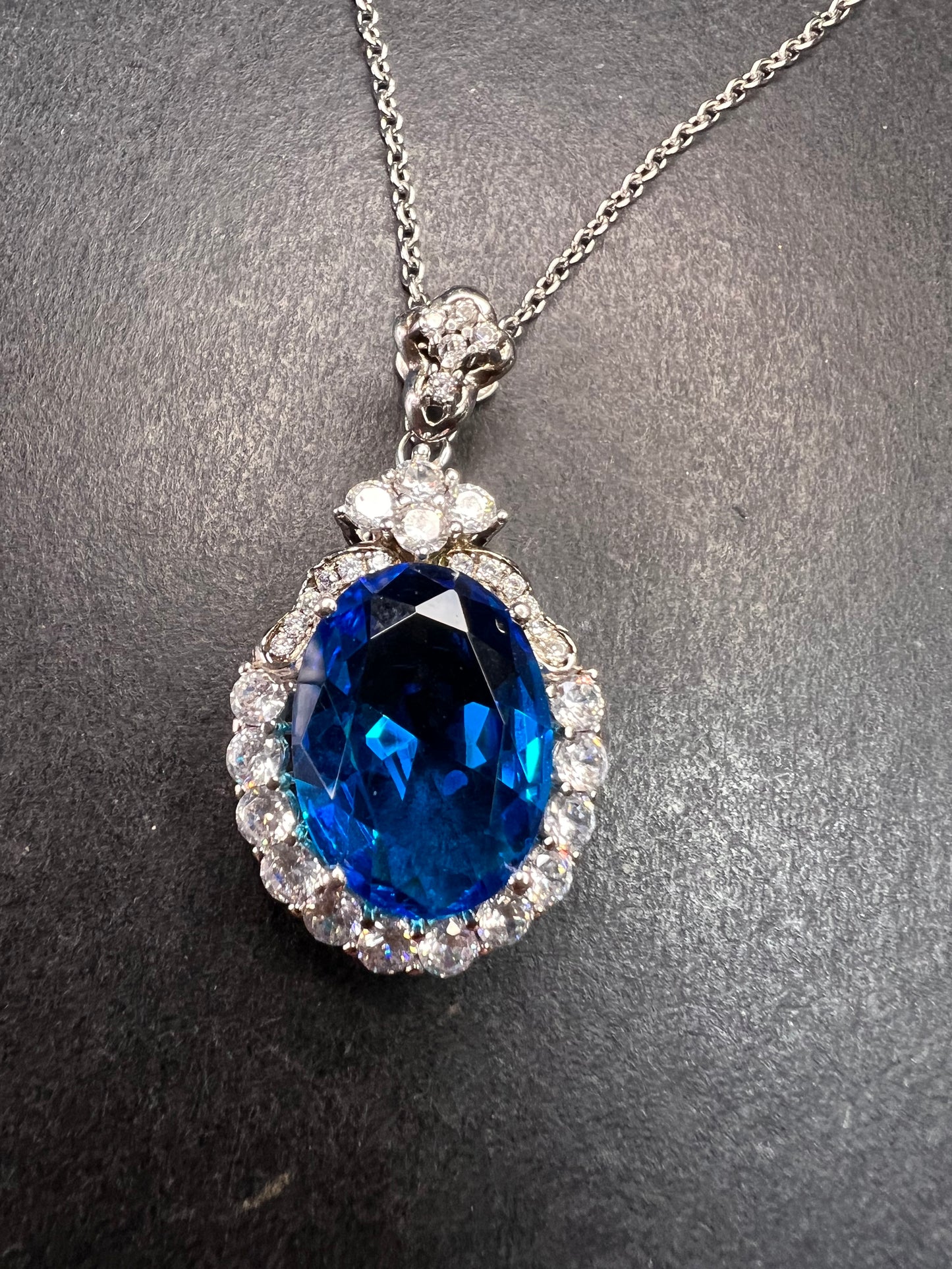 Blue and white CZ sterling silver halo pendant