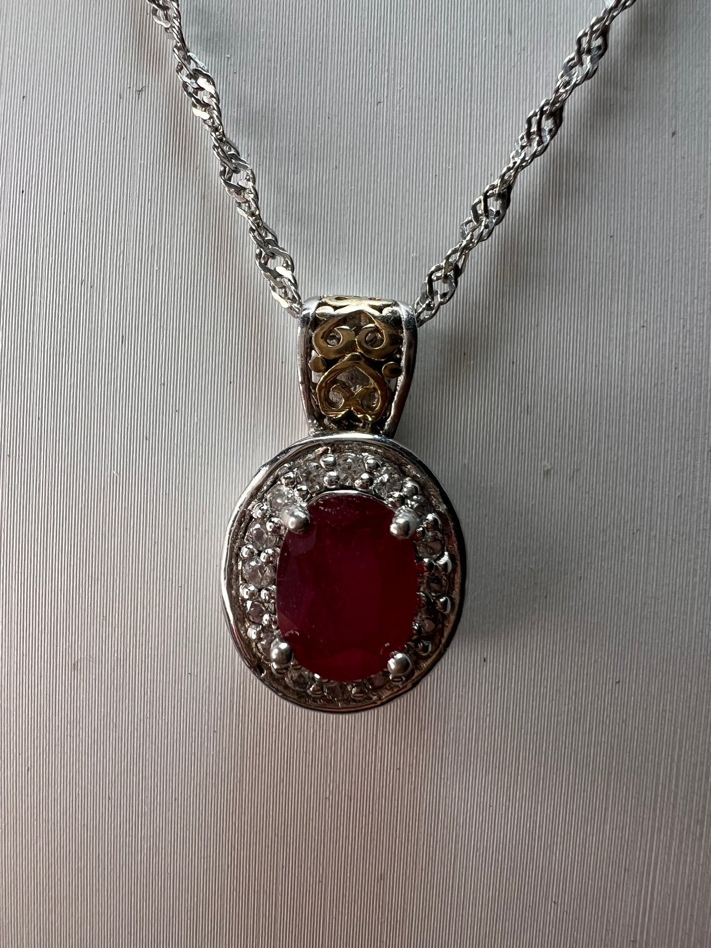 Ruby and zircon two toned halo pendant and chain necklace in sterling silver