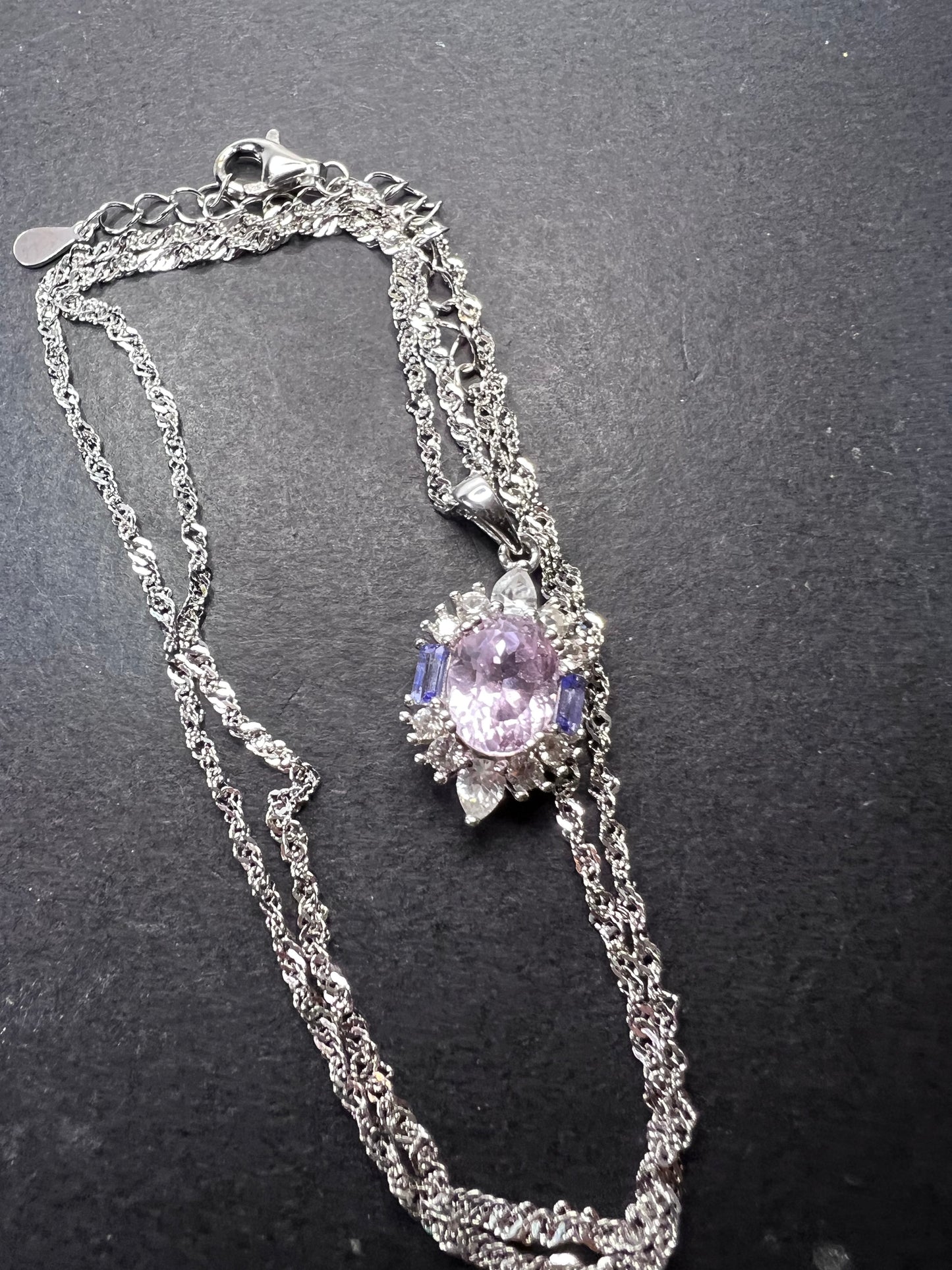 2.11ct Kunzite, 0.18ctw Tanzanite And 0.87ctw White Zircon Rhodium Over Silver halo Pendant With Chain