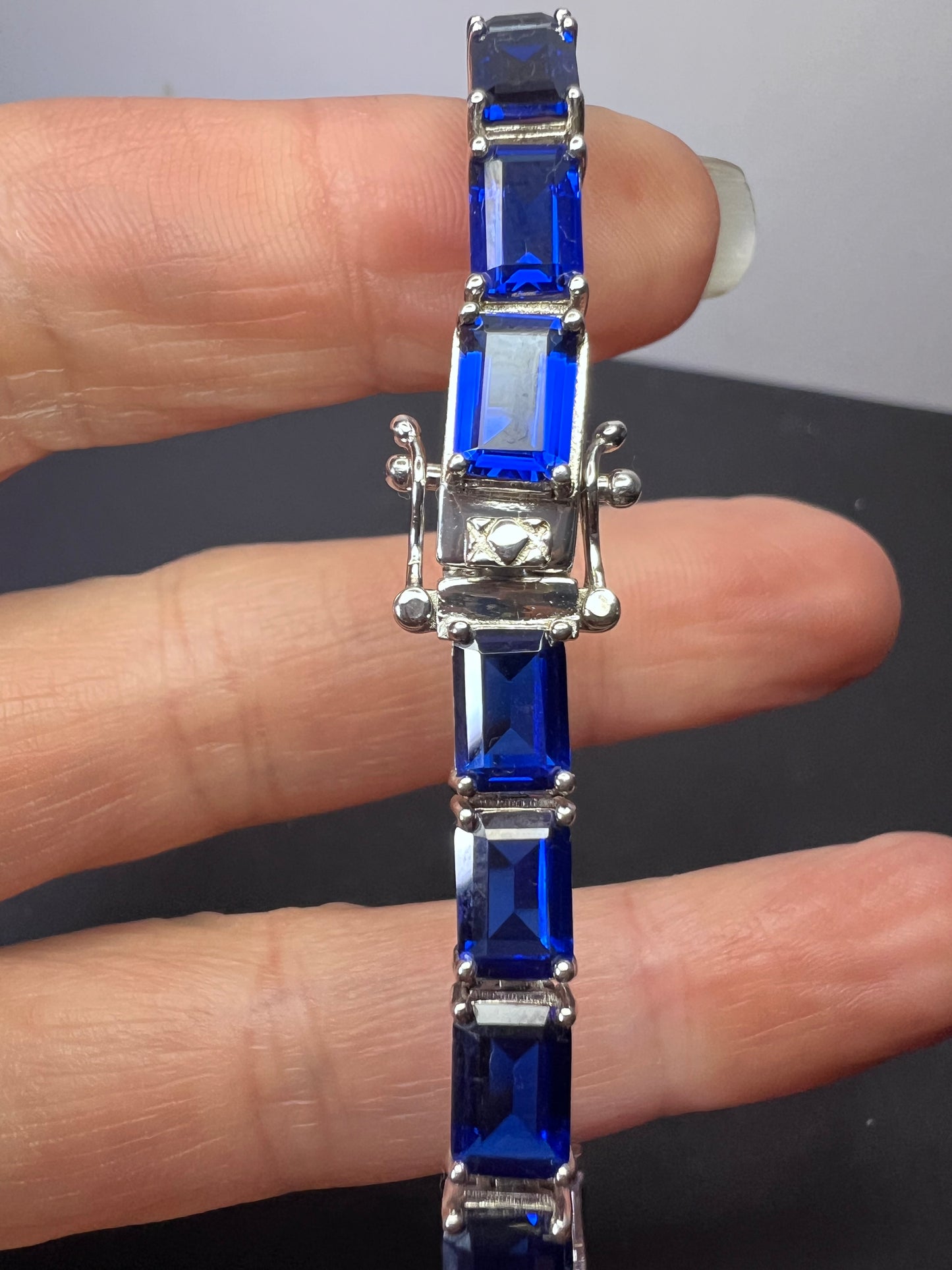 Lab created blue spinel emerald cut tennis bracelet in platinum over sterling silver 22.92 ctw