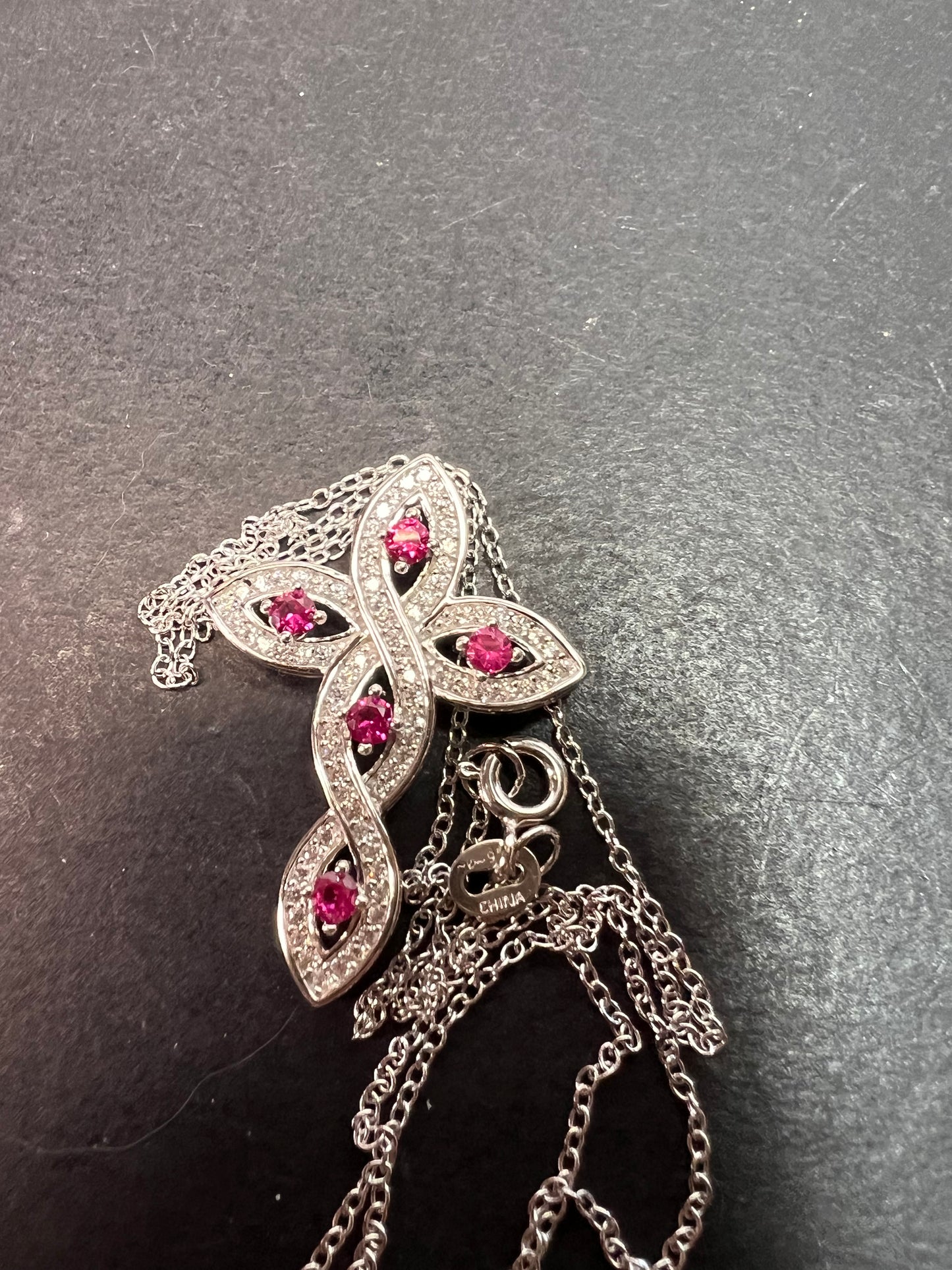 Lab grown ruby and CZ cross pendant and chain necklace in rhodium over sterling silver 18 inch