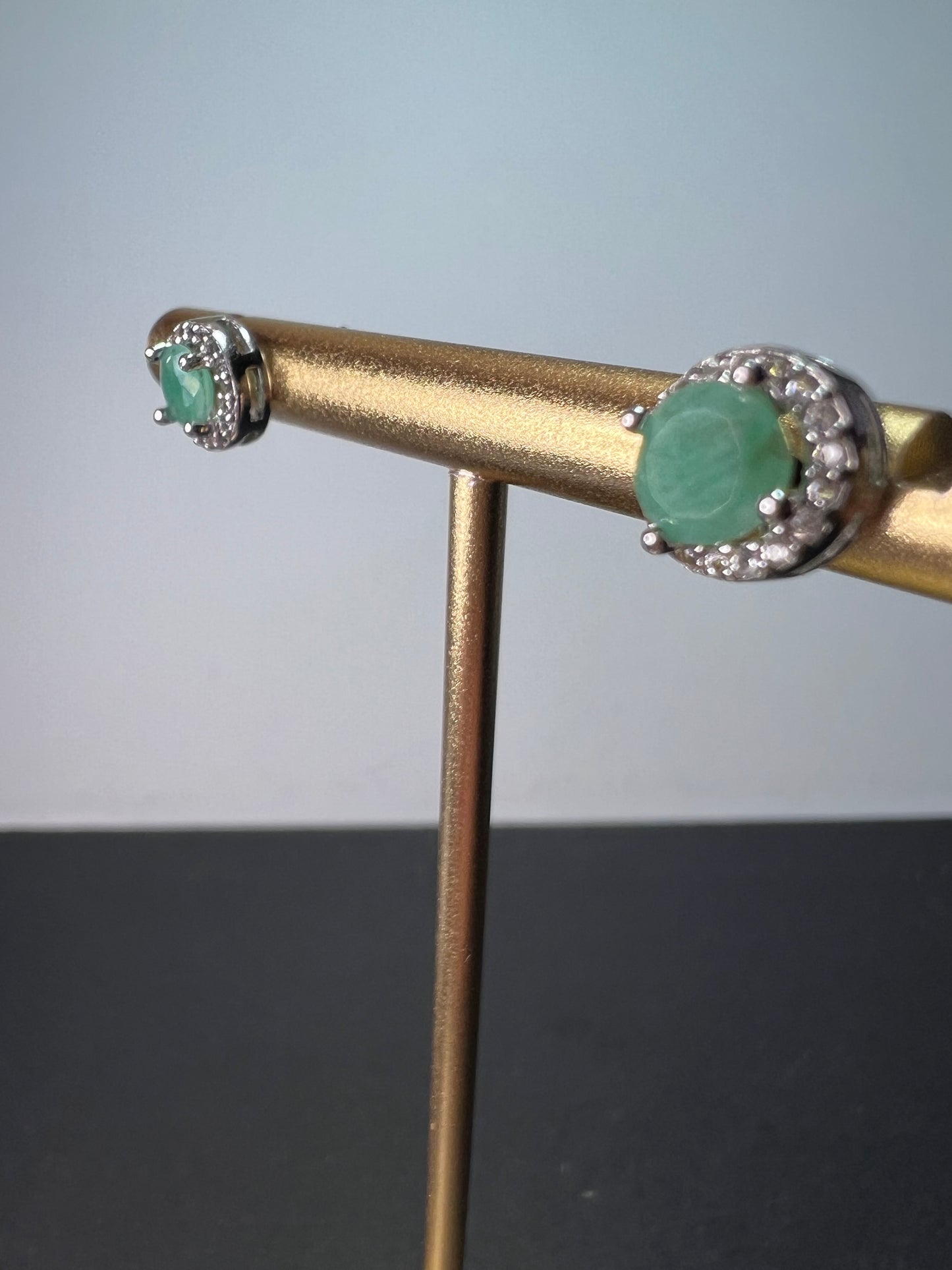 Emerald and zircon halo stud earrings in sterling silver