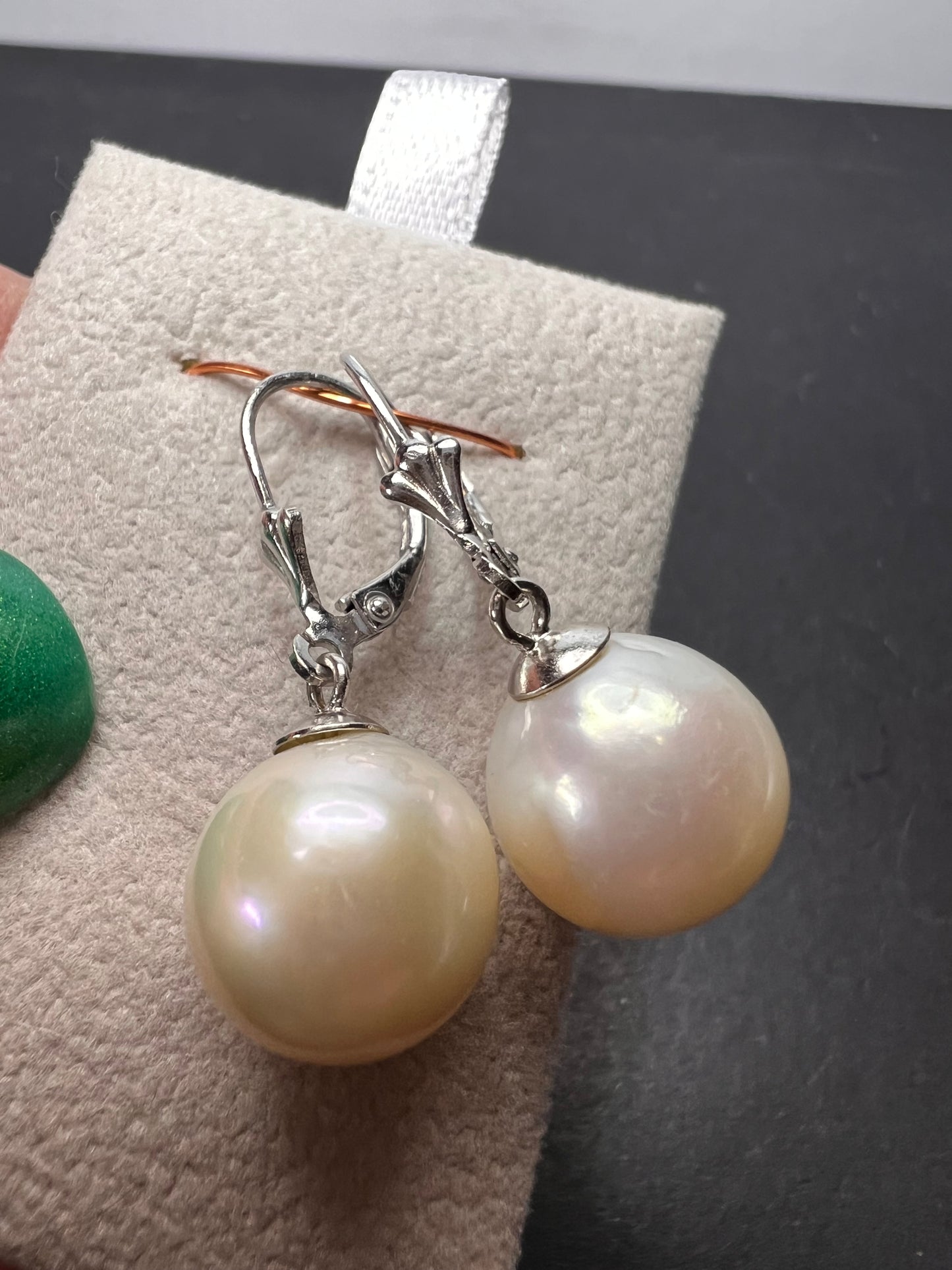 White cultured freshwater pearl earrings in rhodium over sterling silver lever backs