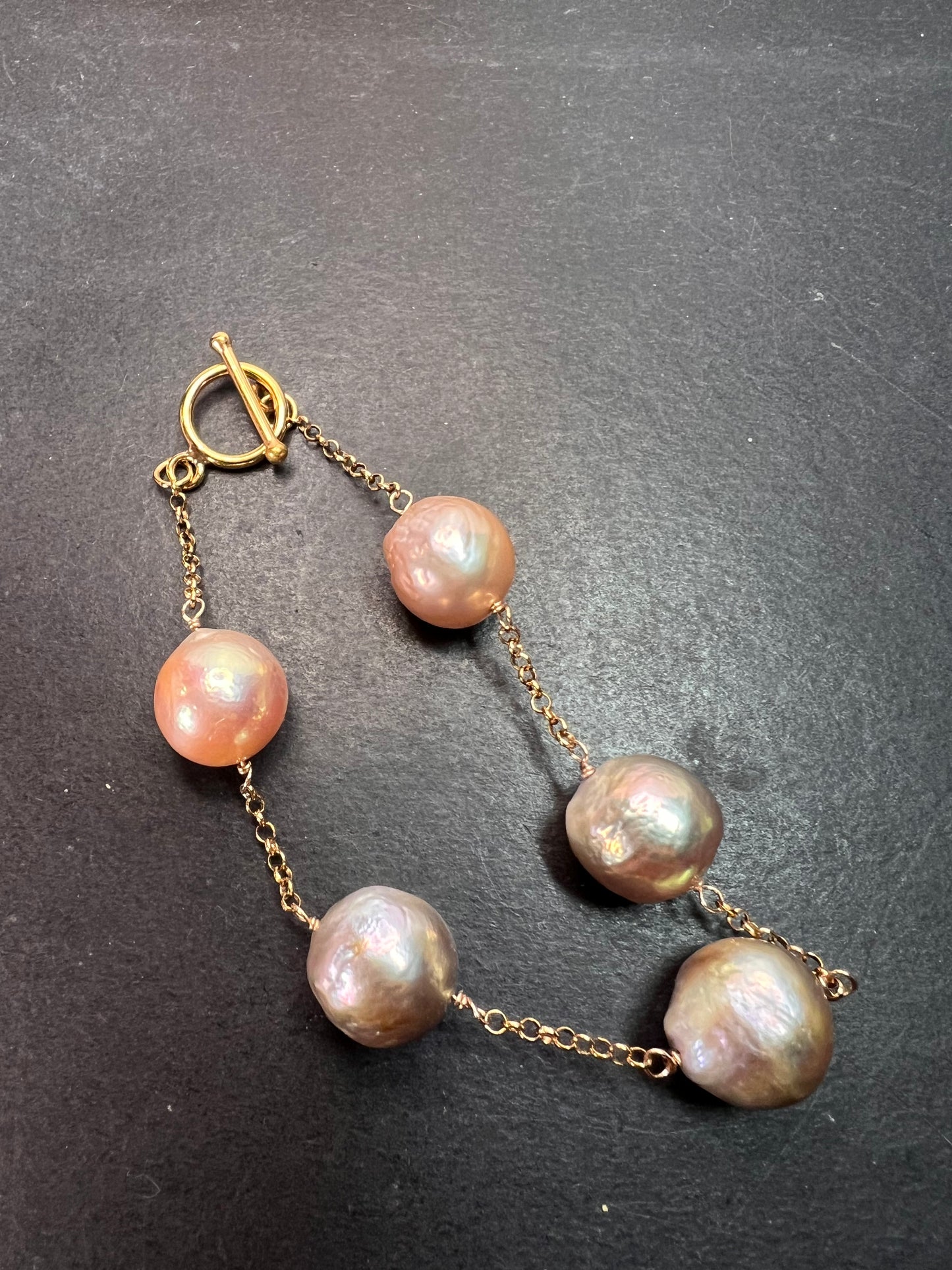 Multi colored baroque pearl station bracelet in rose gold over Sterling silver