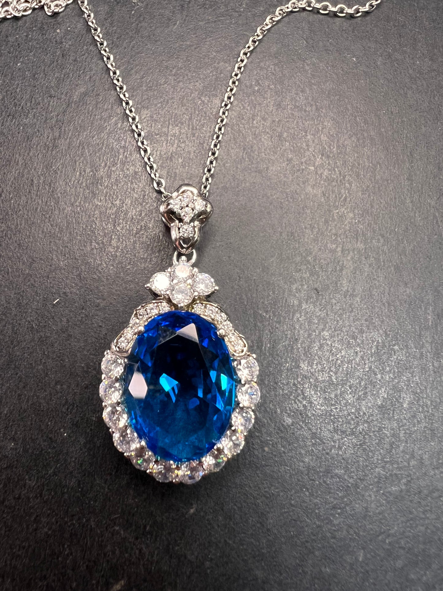 Blue and white CZ sterling silver halo pendant
