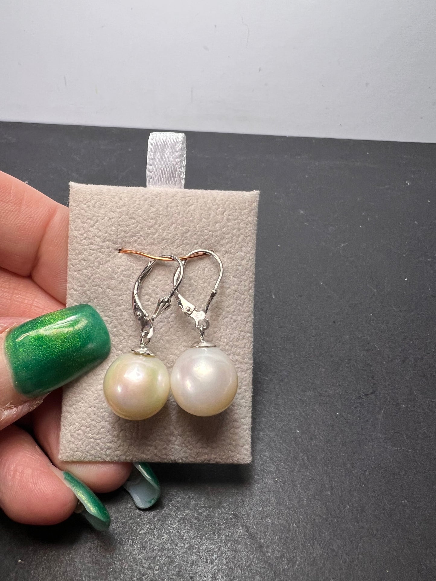 White cultured freshwater pearl earrings in rhodium over sterling silver lever backs