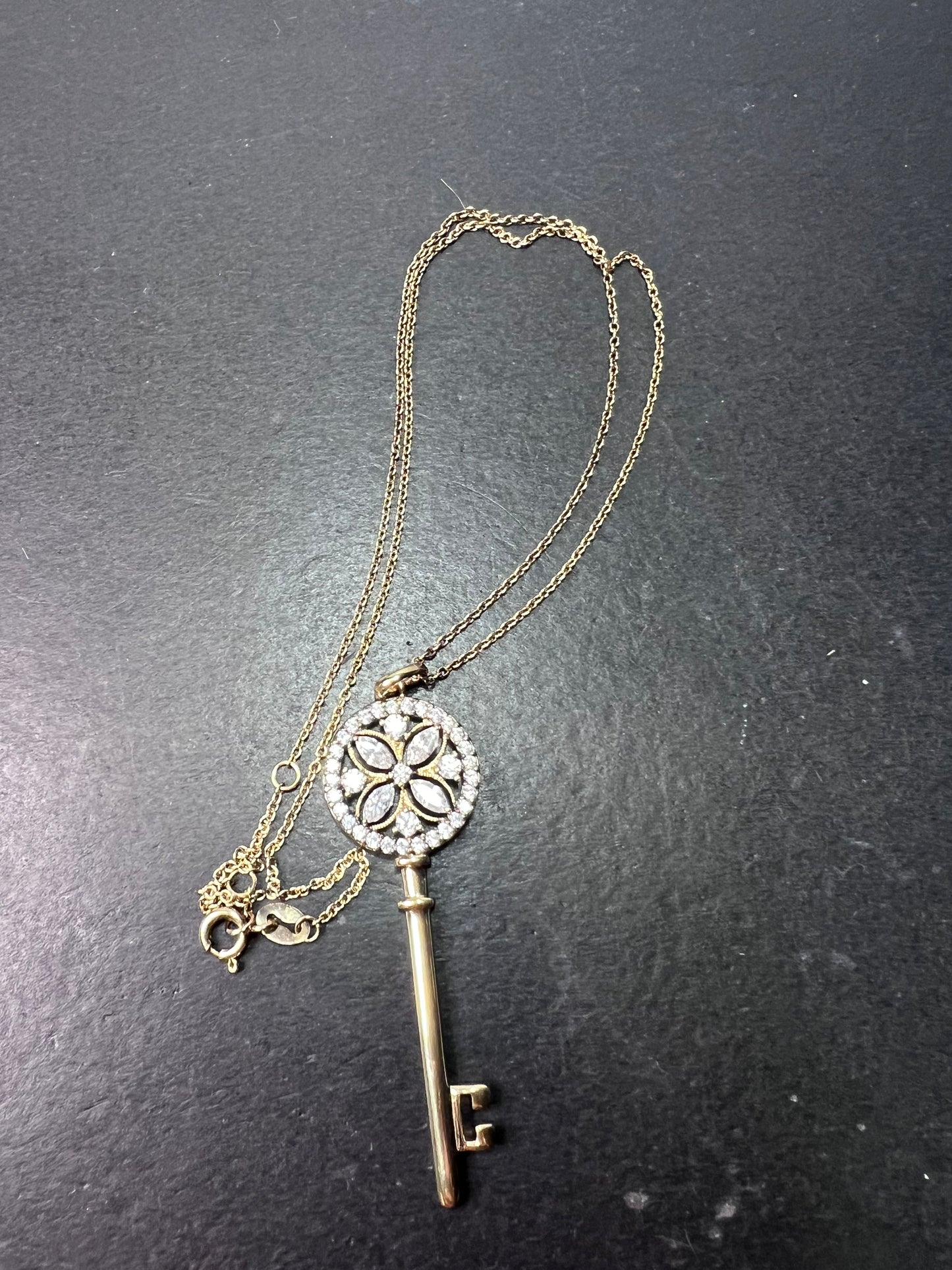 Gold over sterling silver key pendant necklace with Cz stones