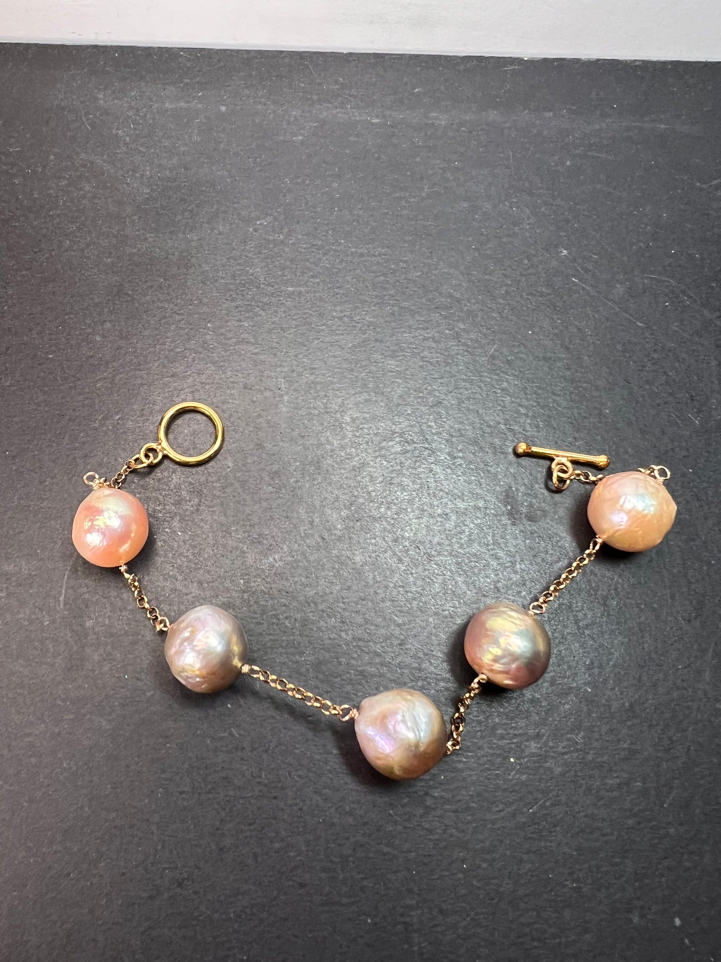 Multi colored baroque pearl station bracelet in rose gold over Sterling silver