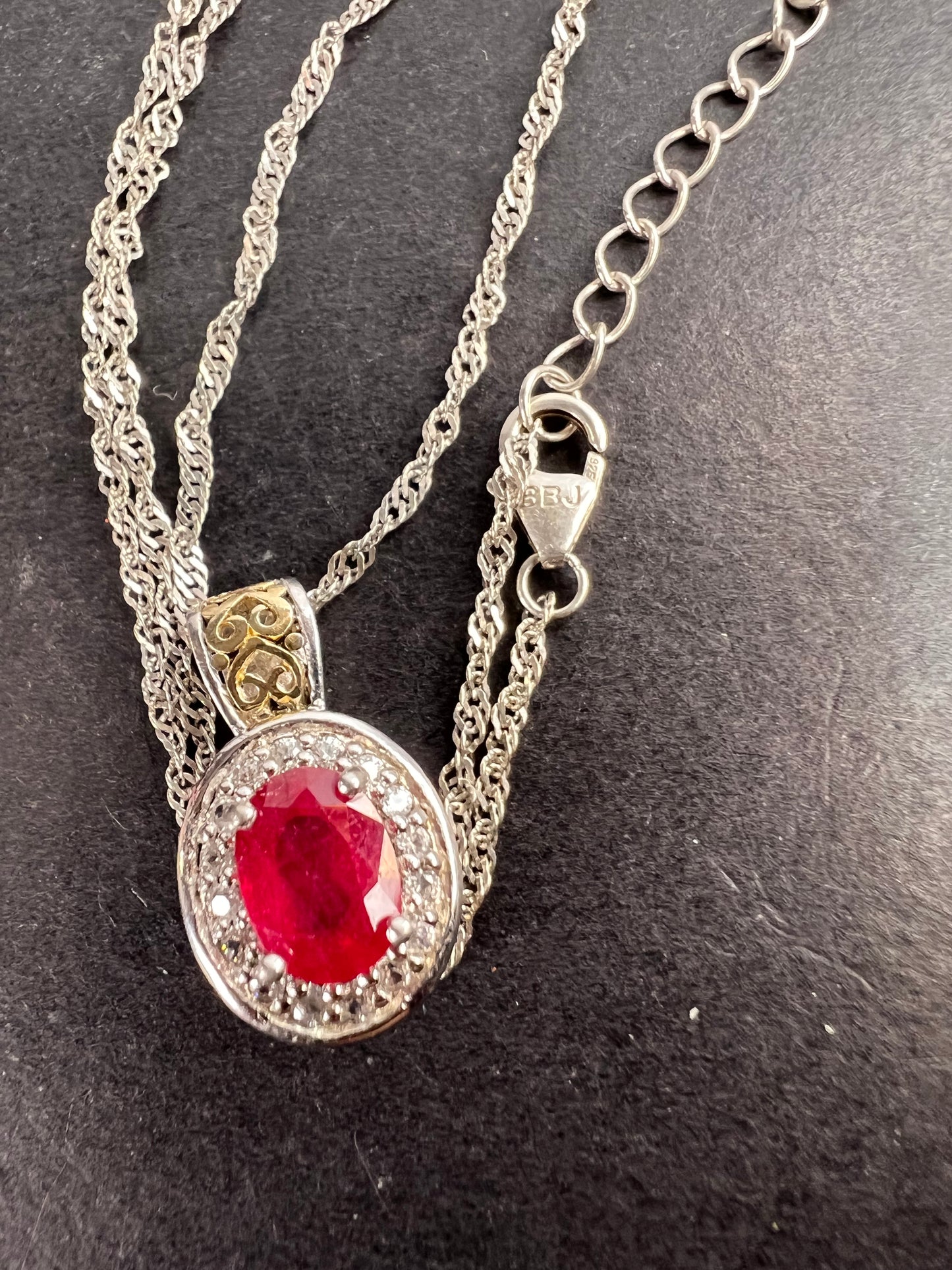 Ruby and zircon two toned halo pendant and chain necklace in sterling silver