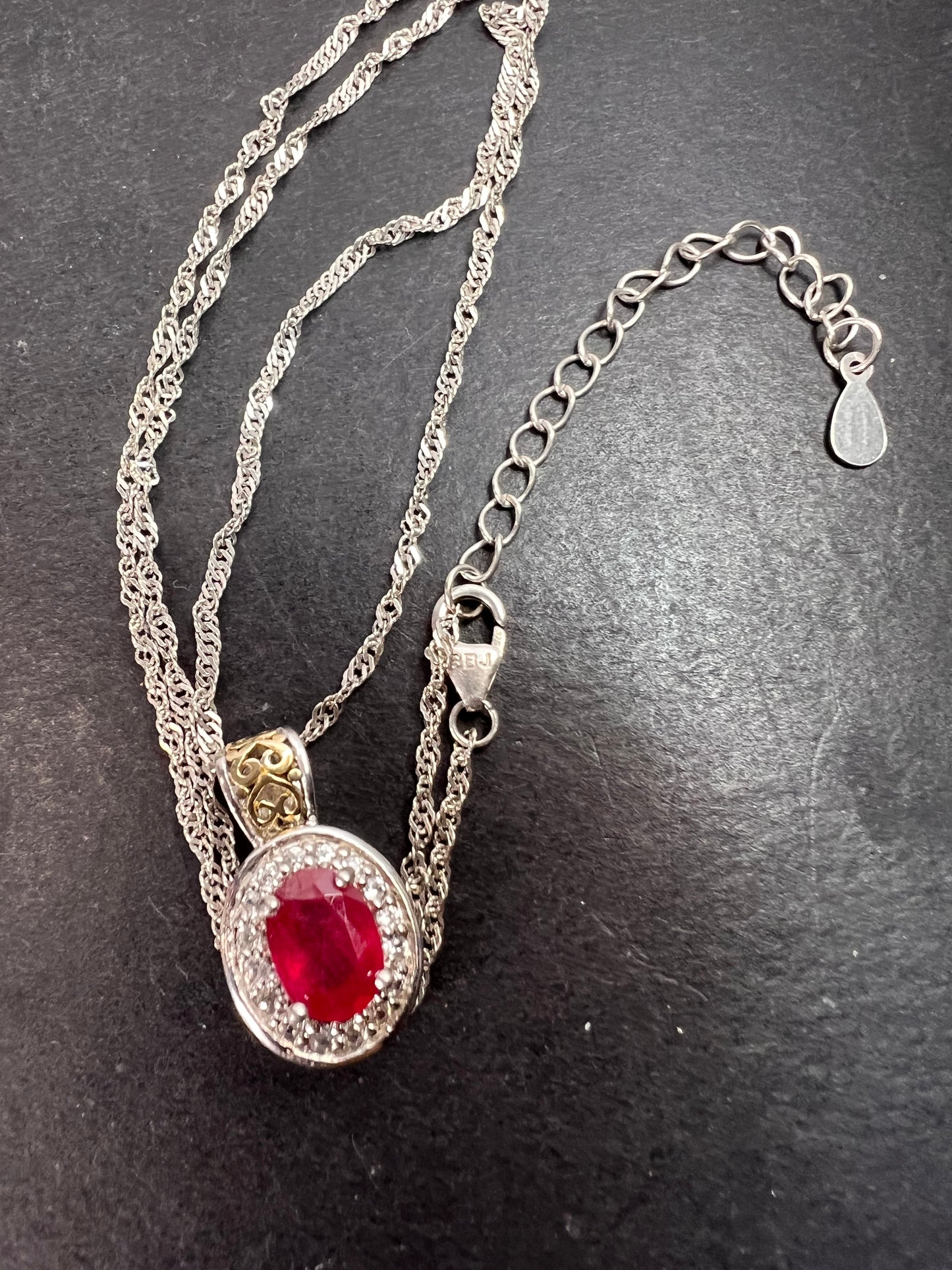 Ruby and zircon two toned halo pendant and chain necklace in sterling silver