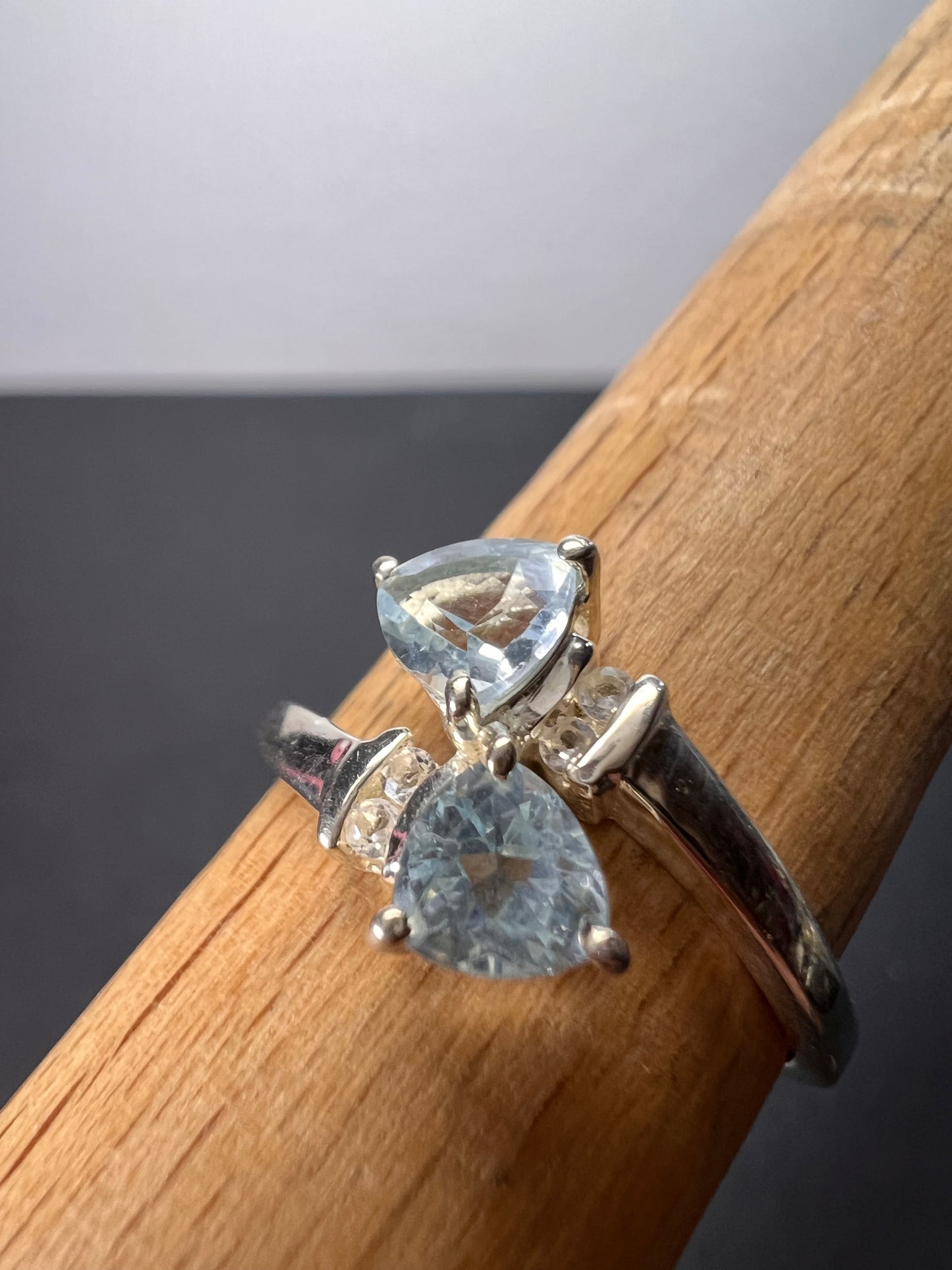 Trillion cut blue topaz bypass ring in rhodium over sterling silver size 9