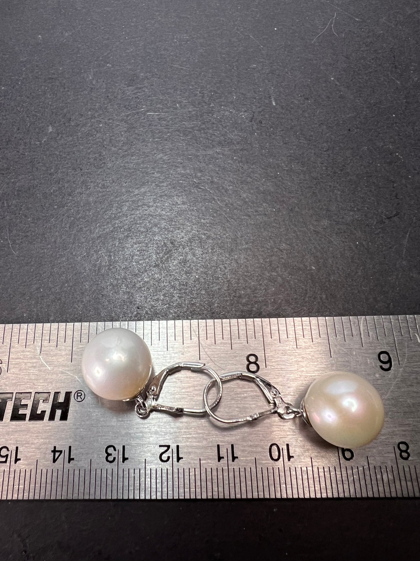 White cultured freshwater pearl earrings in rhodium over sterling silver lever backs