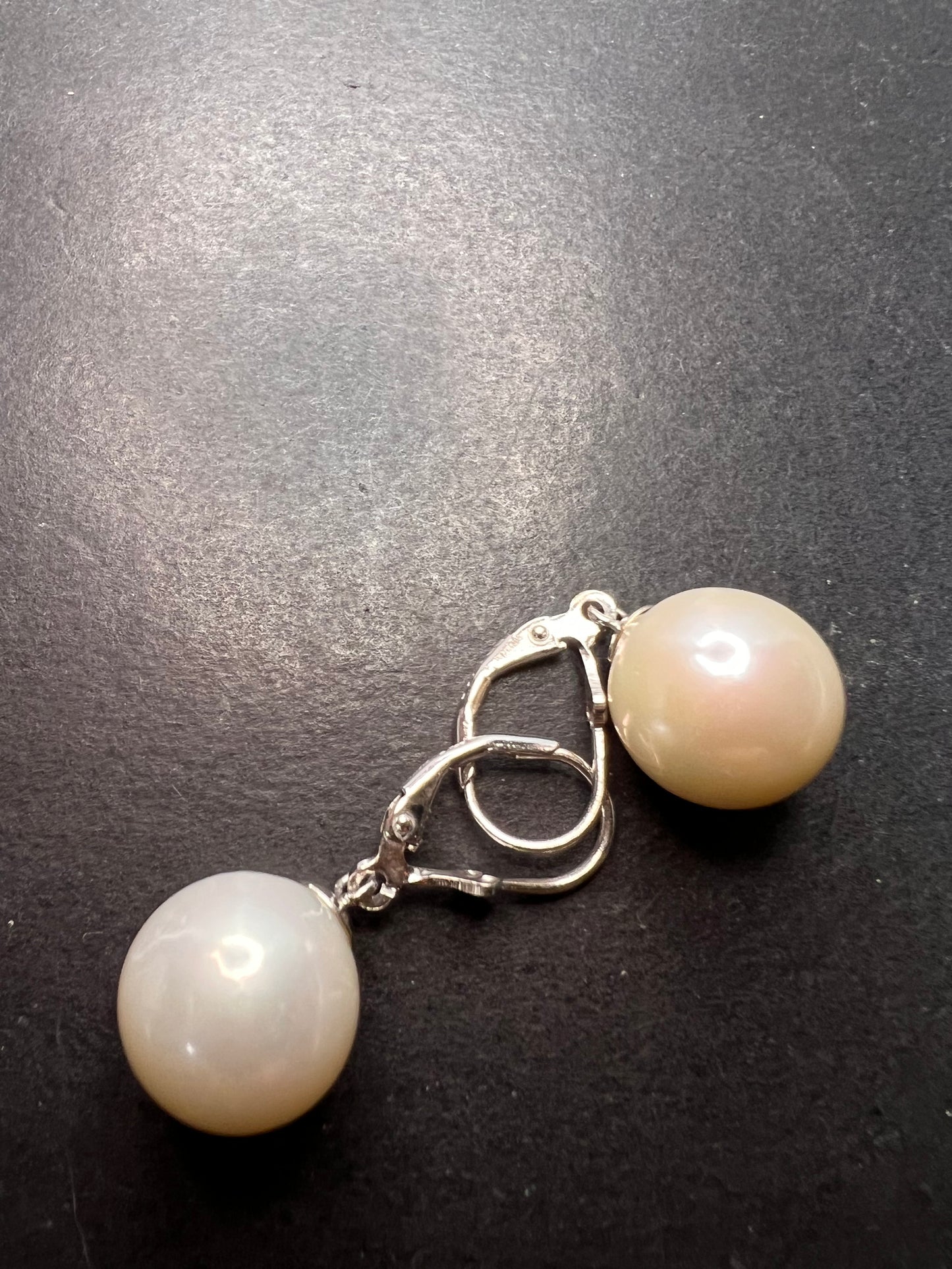 White cultured freshwater pearl earrings in rhodium over sterling silver lever backs