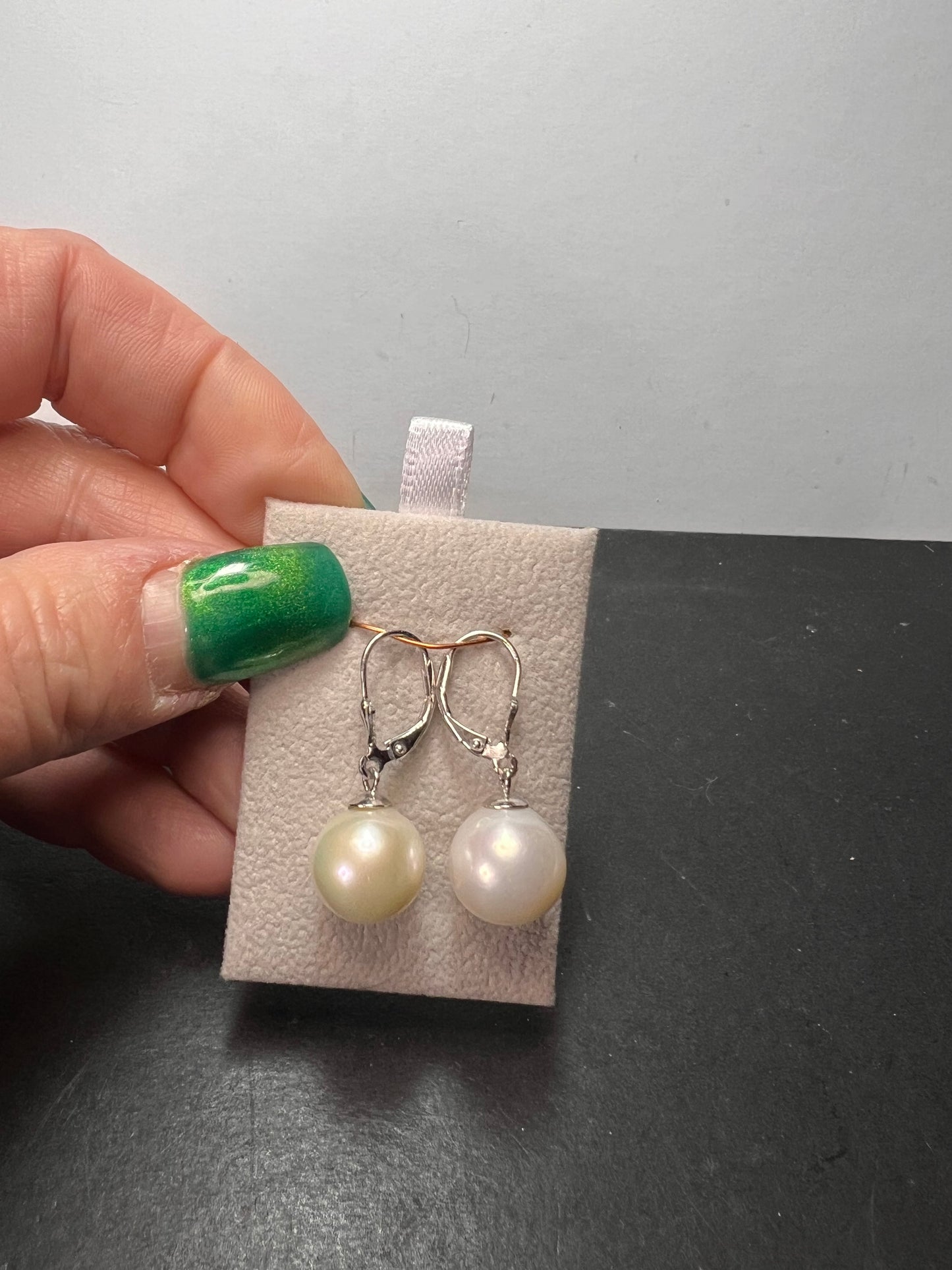 White cultured freshwater pearl earrings in rhodium over sterling silver lever backs