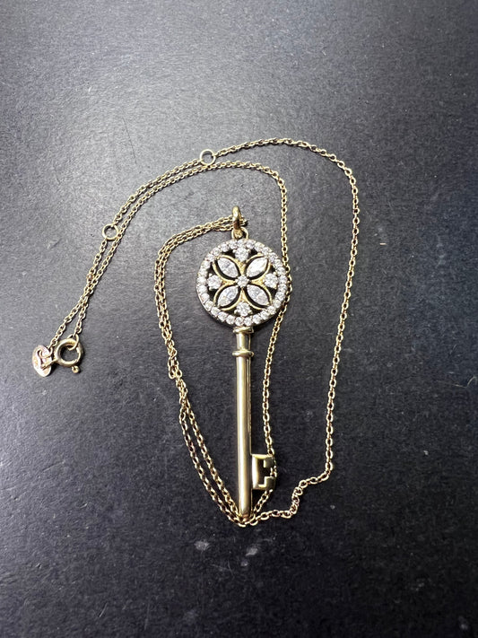 Gold over sterling silver key pendant necklace with Cz stones