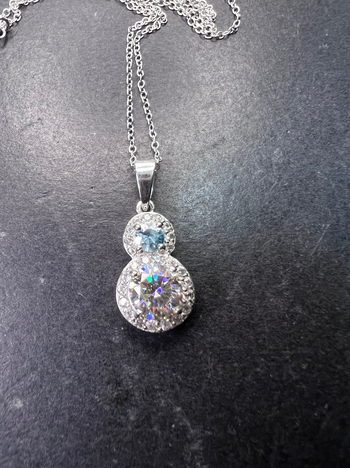 Strontium titanate and blue topaz sterling silver halo pendant with 18 inch chain necklace